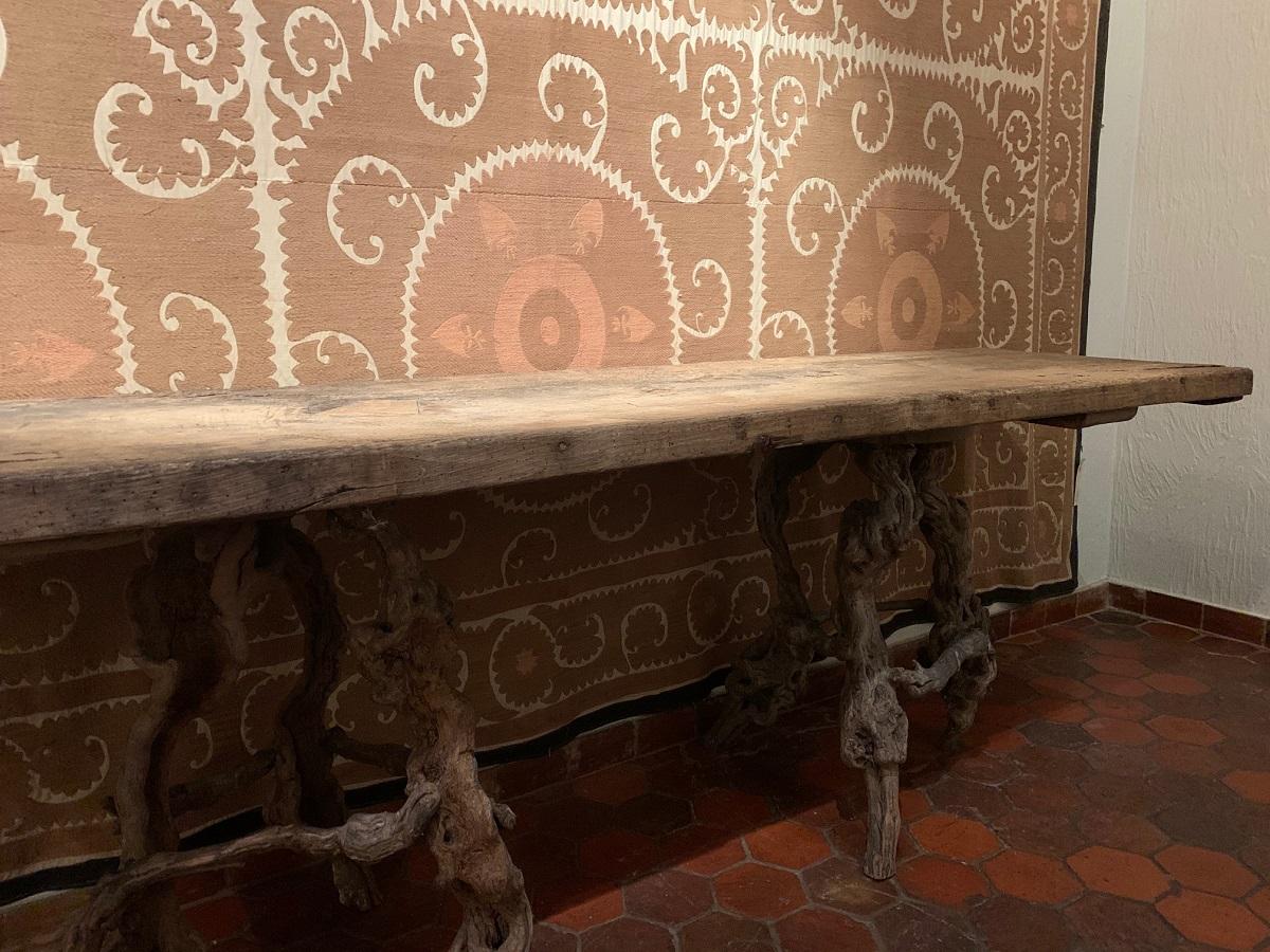 A large console table with one slab oak 17th century top on 19th century Winebranch Consoles. The top beautifully dryed with old insets and the trestles incrusted with old paint remains.