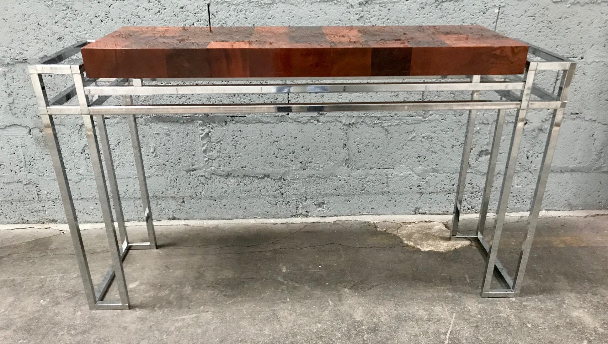 A 1970s console table in varnished wood inlay and chrome in the style of Willy Rizzo.