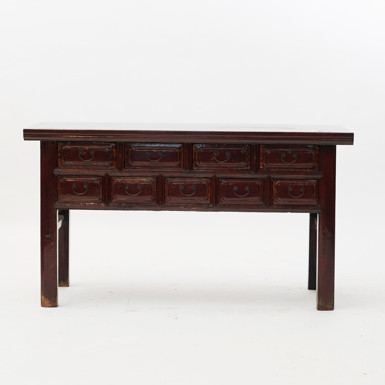Console table with 9 drawers, original deep red lacquer. Crafted in walnut with stunning patina. From Shanxi Province, China, 1830-1840.
Well suited both against a wall, behind sofa or as stand alone table.
      