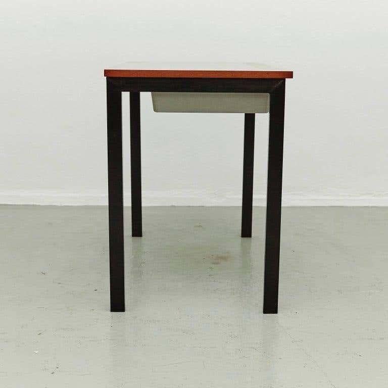 Console designed by Charlotte Perriand, circa 1958.
Manufactured in France, circa 1958.
Laminated plastic-covered plywood, painted steel and grey moulded plastic.

 Drawer moulded with Modele Charlotte Perriand or Brevete S.G.D.G.

In good
