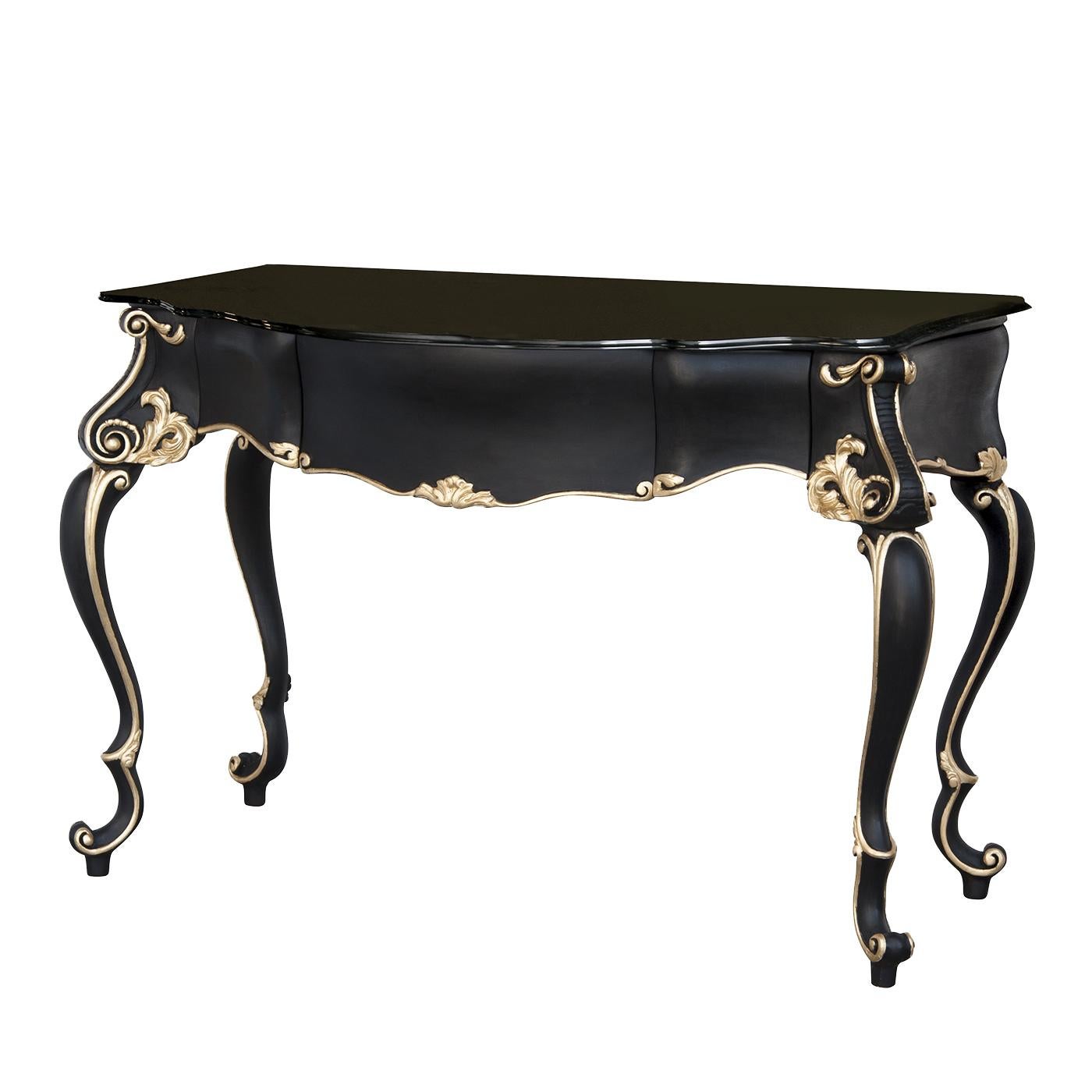 This splendid console, inspired by the bold style of Baroque art, was crafted of solid wood that was carved by hand and finished with an elegant matte black with details in gold leaf. The top is in precious black Marquina marble. A stunning addition