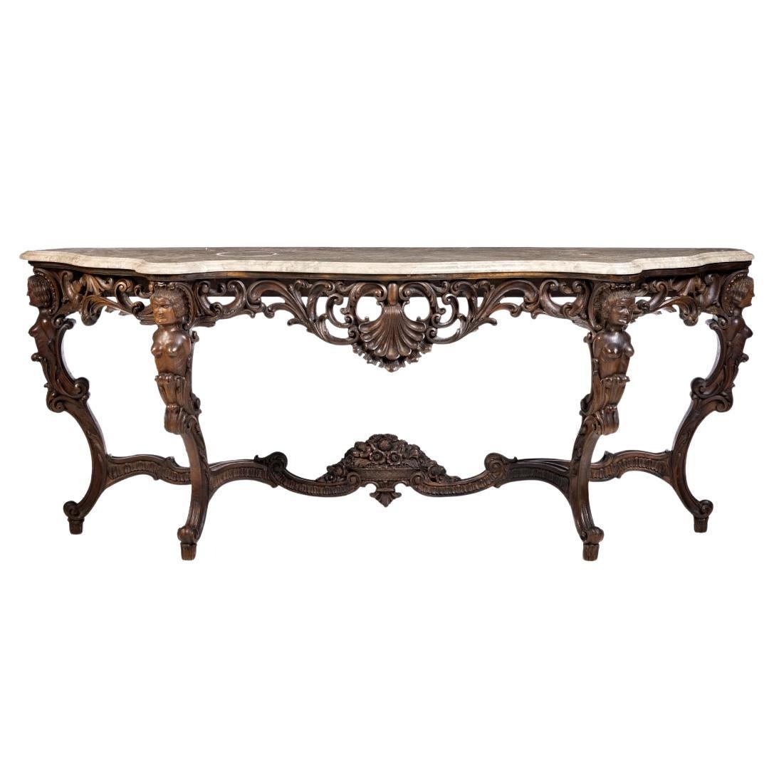 CONSOLE WITH MIRROR IN LOUIS XV STYLE Early 20th century. 
in carved walnut wood, resting on four feet decorated with female figures and floral motifs. 
Marble top in beige tones. 
Dim.:(Console) 90 x 222 x 60 cm; 
(mirror) 108 x 180 cm
very good