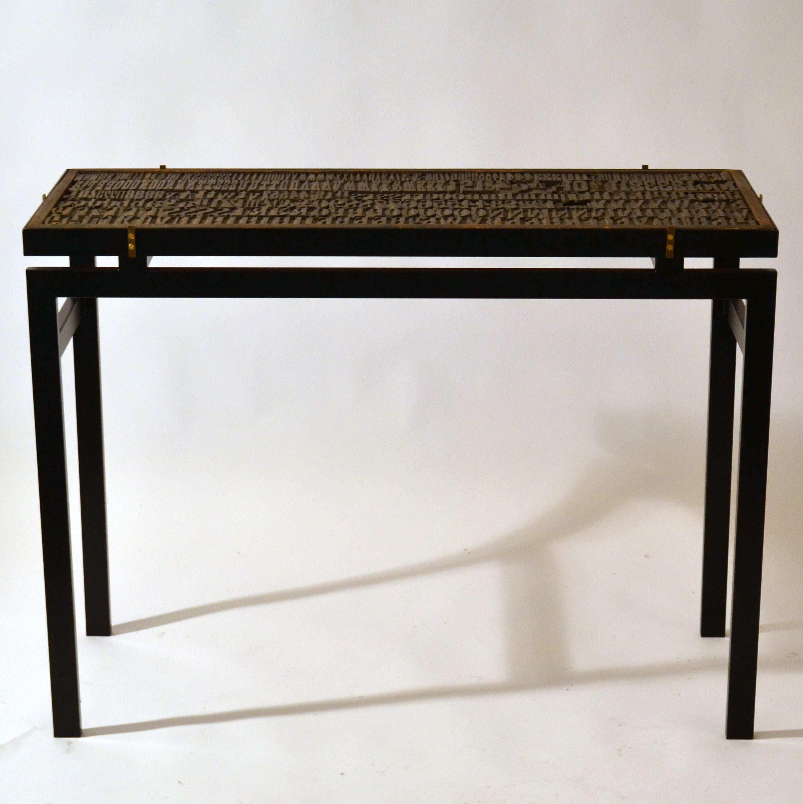 Modern Console with Relief Top of Printing Blocks and Glass op on Black Metal Frame For Sale