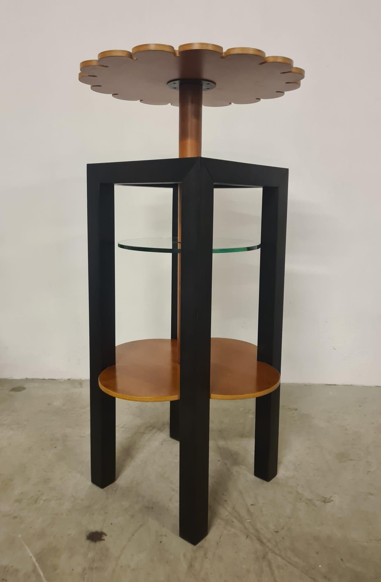 Tall console table attributed to Giorgetti.

Unusual tall center table/console from different geometric shapes inspired by nature.

The main structure consists of four square black metal legs and several flower-shaped tops made of cherry wood and