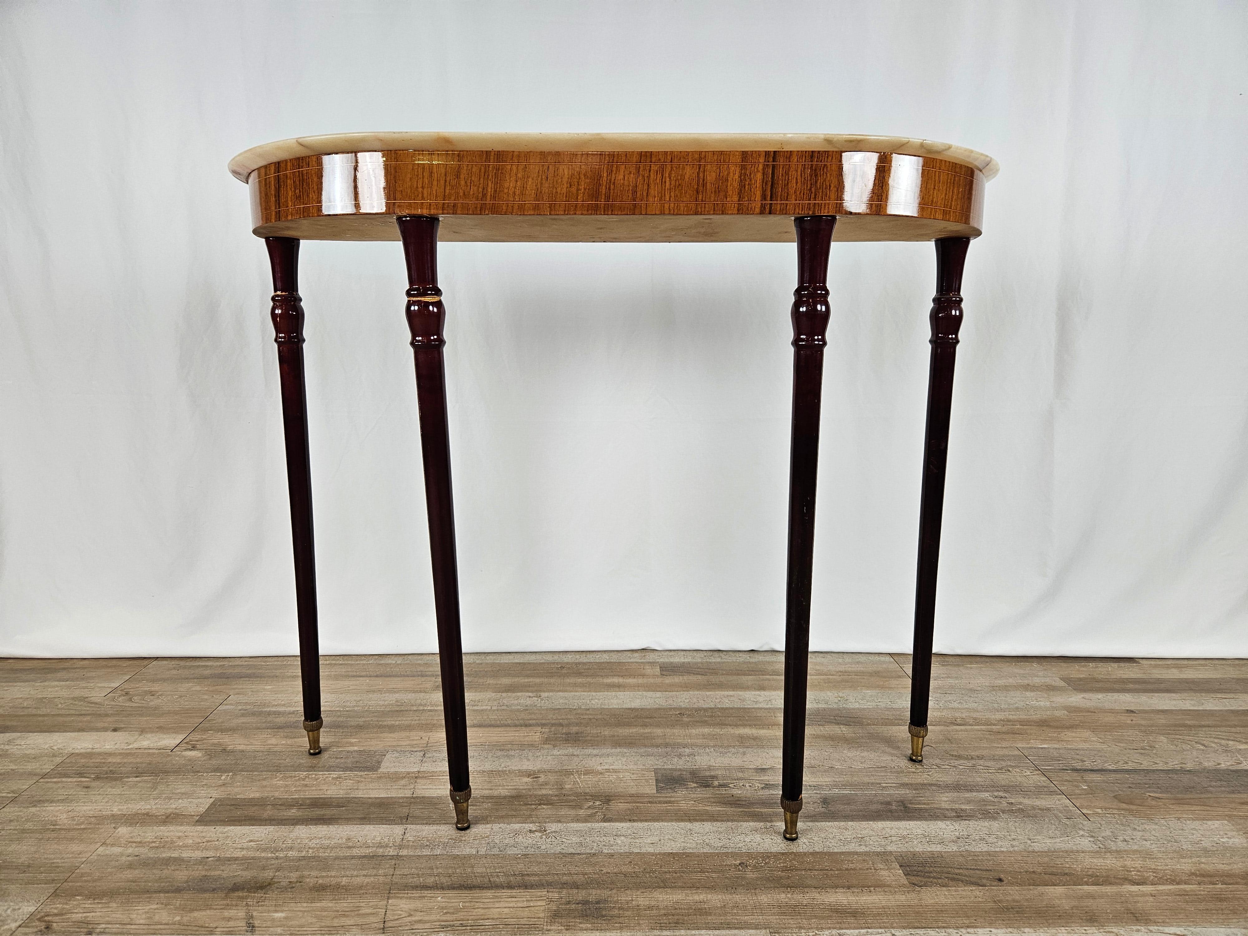 1950s-style entryway console table with marble top and four high legs with brass ferrules.

As visible from the photos the second leg is crooked but the cabinet is stable.
Marble marbled in right rear corner.