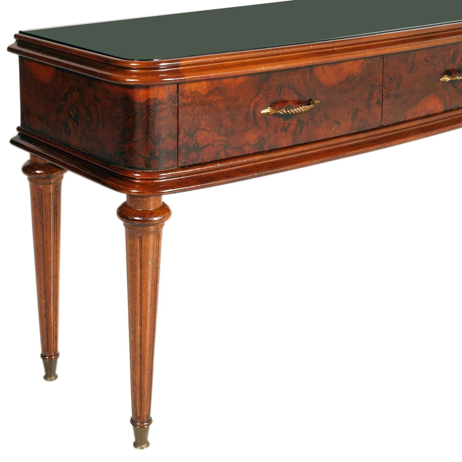 Elegant Mid-Century modern low console with three drawers by Paolo Buffa for Permanente Mobili Cantù in walnut root. Accessories such as handles and feet in golden brass.
Top in lacquered glass.


PAOLO BUFFA
Italian architect and designer Paolo