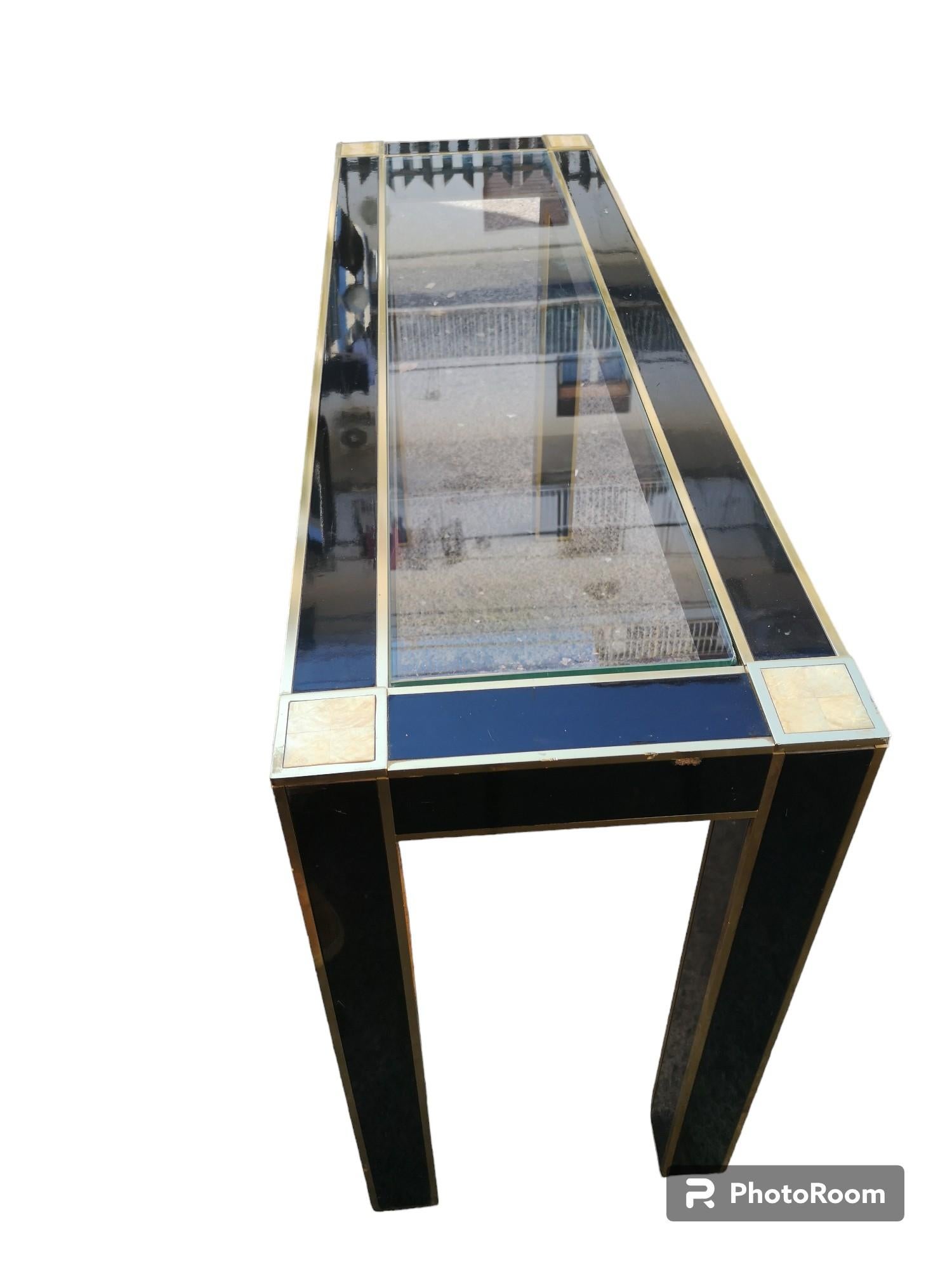 Console table with black lacquered wood frame with crystal top, brass profiles and mother-of-pearl details at corners.
the console measure:
Width   130 cm
Depth    40 cm
Height         74 cm
If interested I can send more detailed photos upon request.