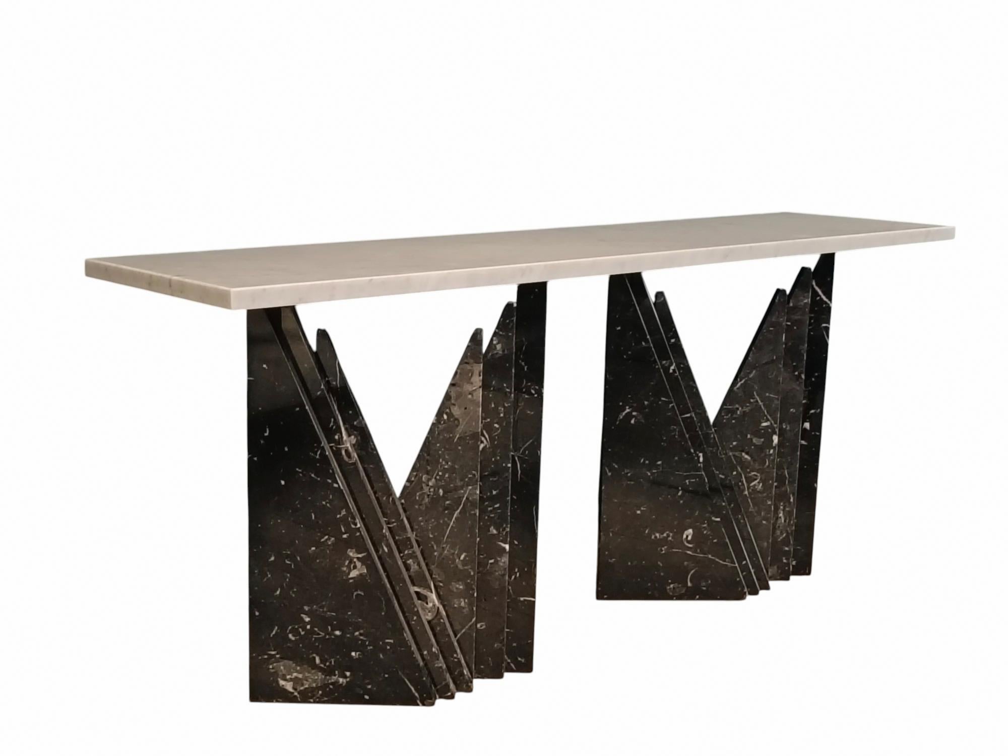 Spendid marble console table. The structure features two imposing bases made of Black Marble  Marquina  worked with an 