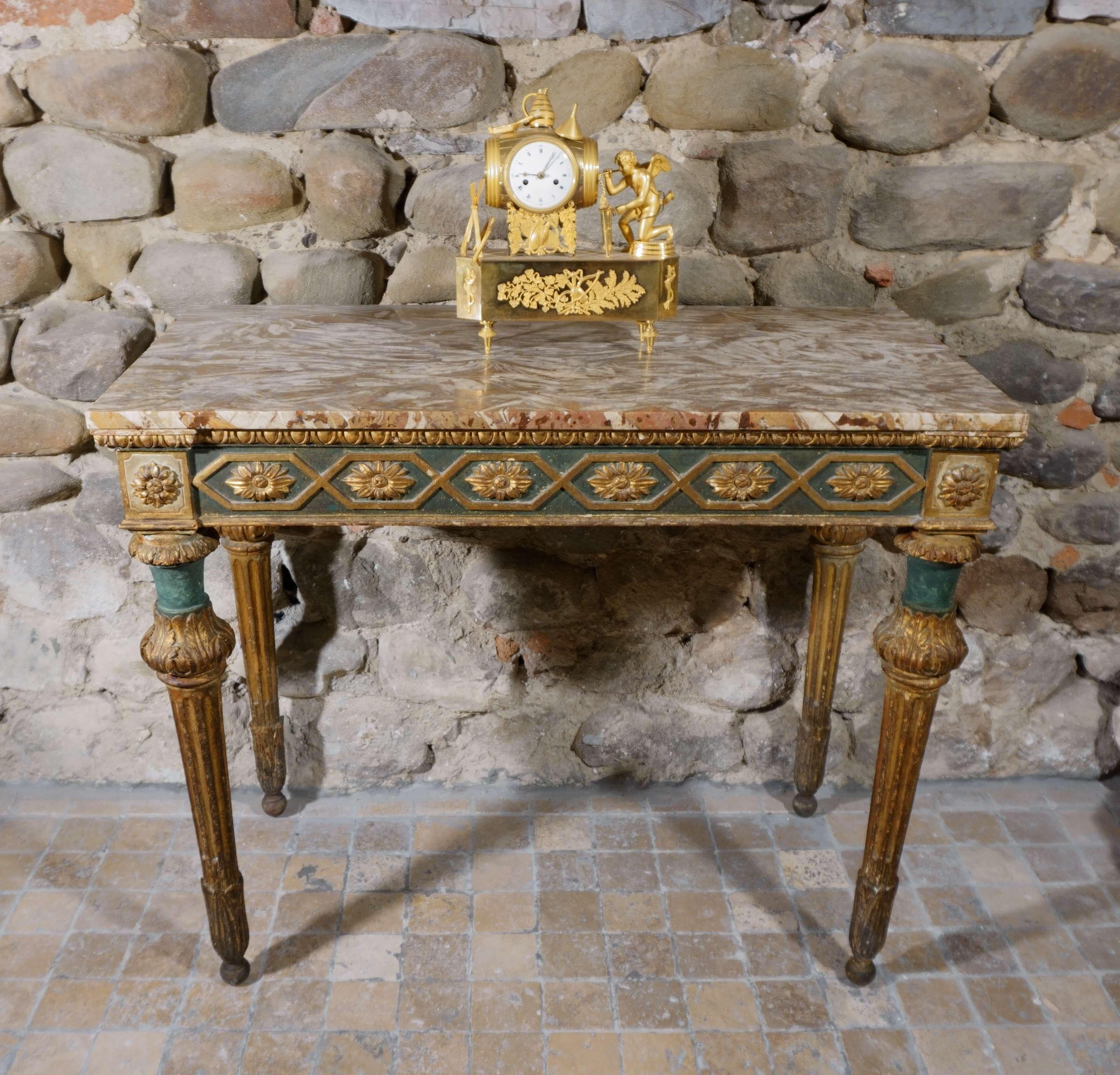 Rare Genoese four-legged console table from the Louis XVI era, 18th century. Made of richly carved, lacquered and gilded wood with snail marble top. The console has a richly carved fascia on three sides with stylized flower motifs, with four scanned