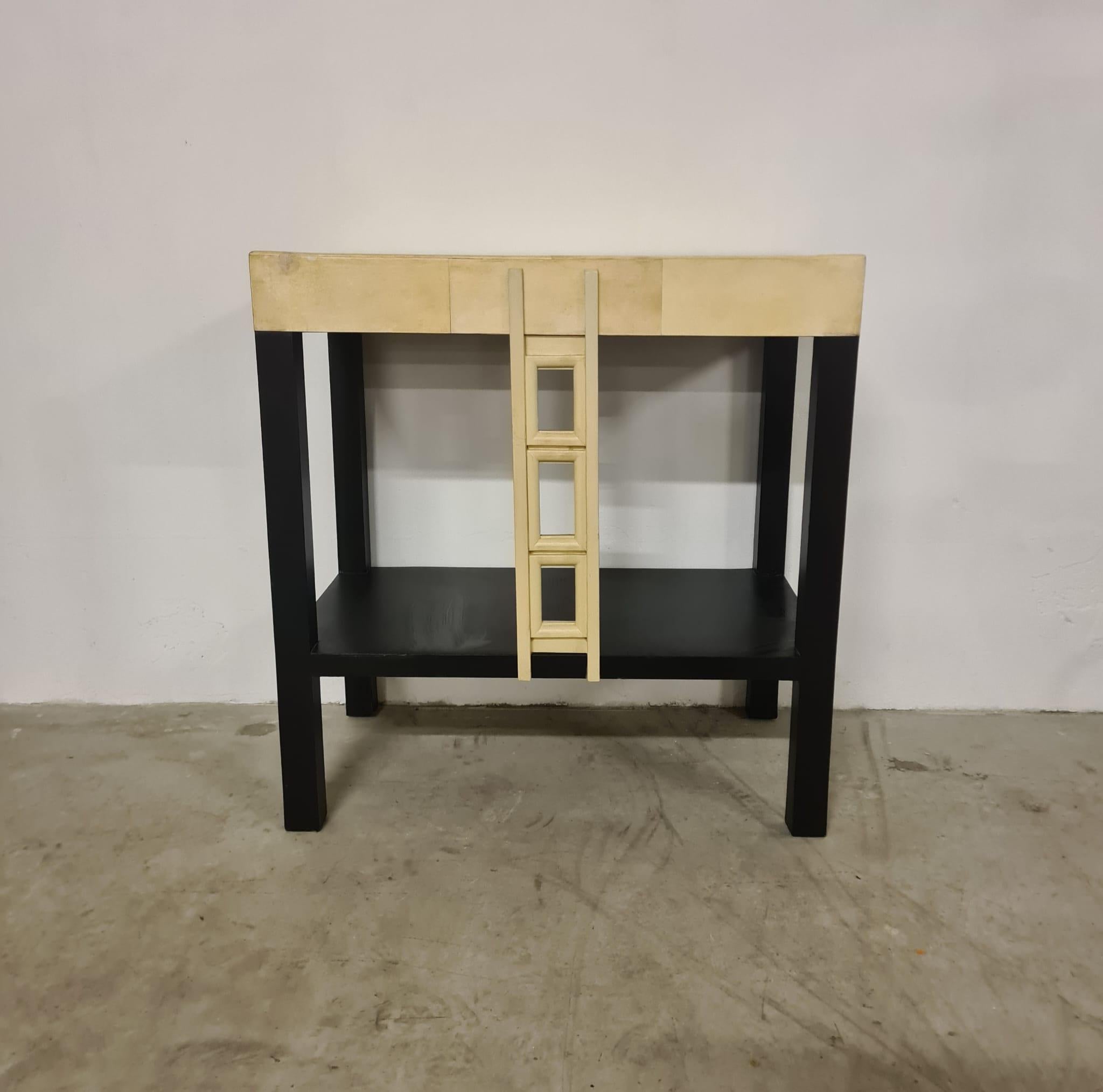 Wall console table

Small lacquered wood wall console table.

The console table features a black lacquered base and a faux parchment lacquered top and front ornamenta.

Ideal as a decorative element in small spaces.

Probable French provenance from