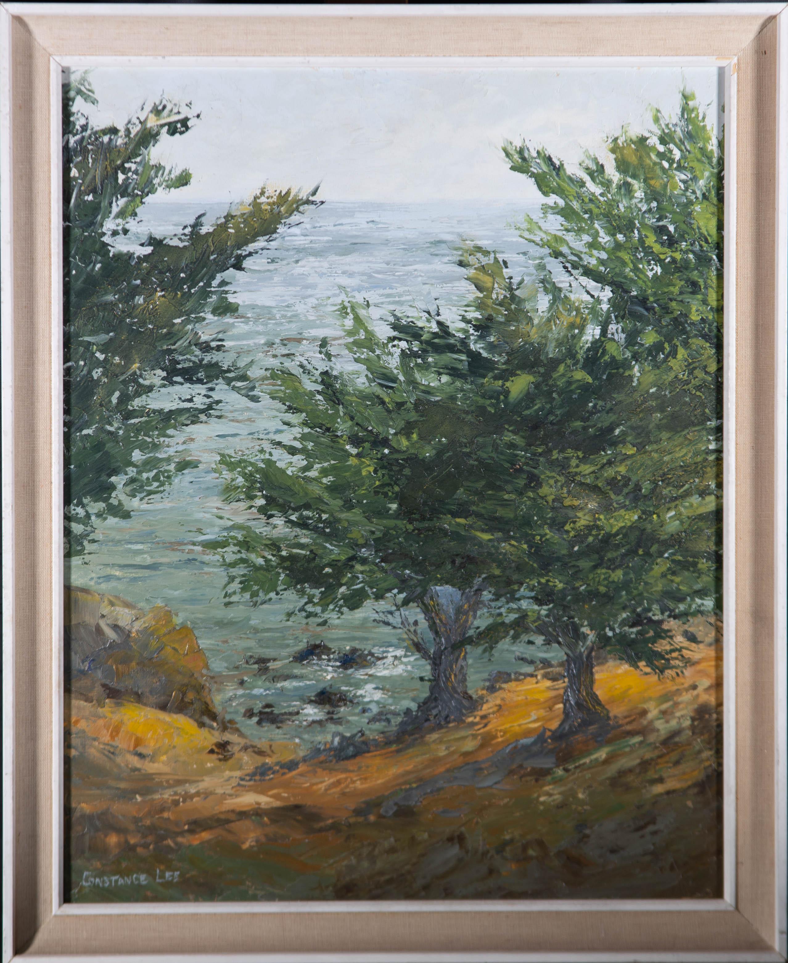 A fine impasto oil painting by Constance Lee, depicting a coastal scene with trees. Signed to the lower left-hand corner. The artist's name and title are inscribed on the reverse. Presented in a white wooden frame with a fabric detail. On canvas