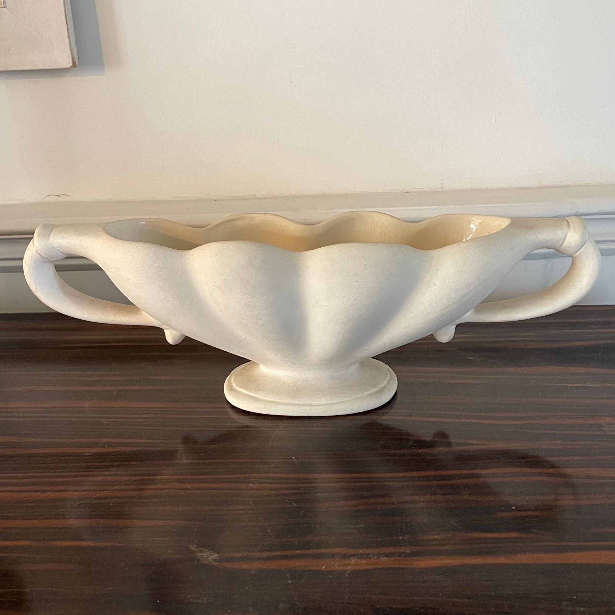 Constance Spry for Fulham Pottery vase circa 1930s 

Desirable scalloped body and curved handles with decorative banding, finished in sought after unglazed cream, formed onto an oval pedestal base. 

Fulham Pottery stamp impressed to the base.