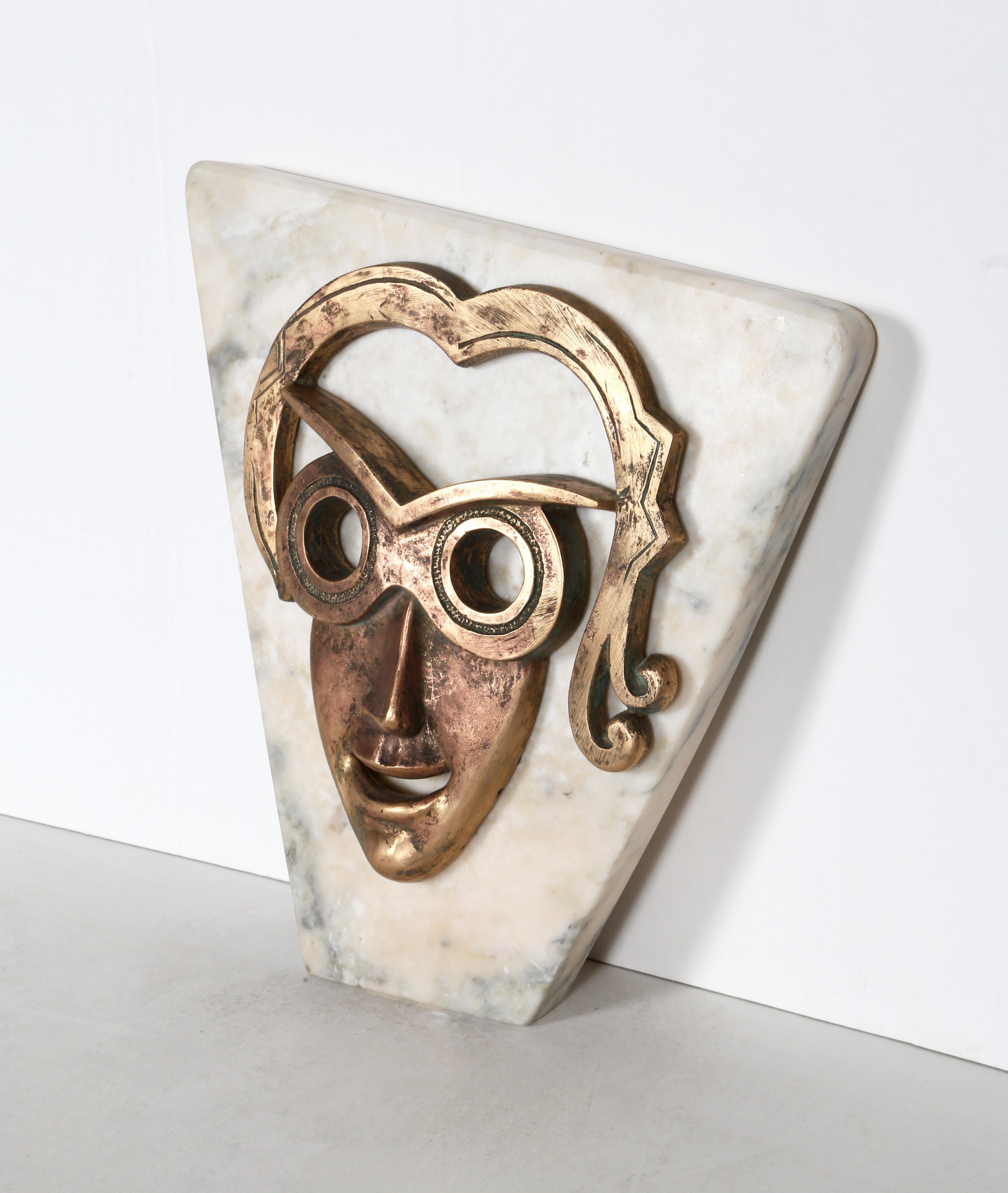 This Bronze portrait by Constantin Antonovici is laid directly into the surface of a cut slab of white marble. Intense and hollow eyes stare out from a smiling visage, creating an unnerving image of a woman trapped in stone.

Ileana
Constantin