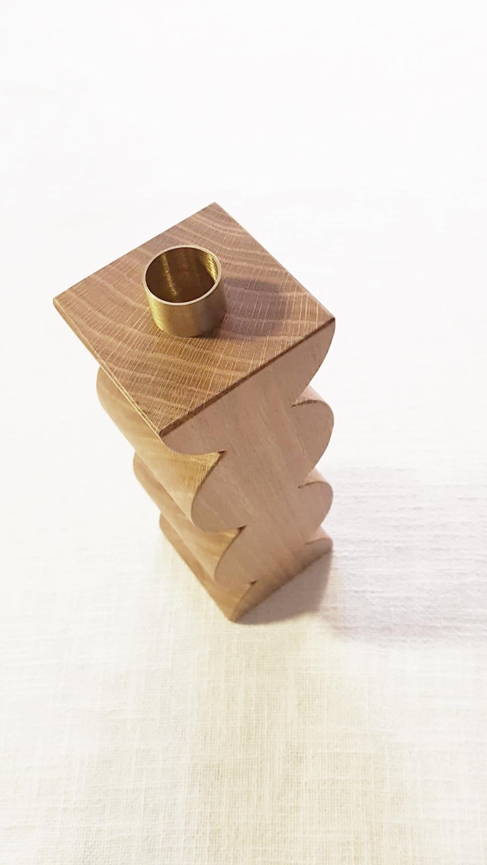 Constantin 1 is a simple but charming candleholder with a geometric shape with circles. The body is in solid oak wood. The cylinder in natural brass on the top is the place where to put a 18 mm candle.
In the same collection 3 different models of