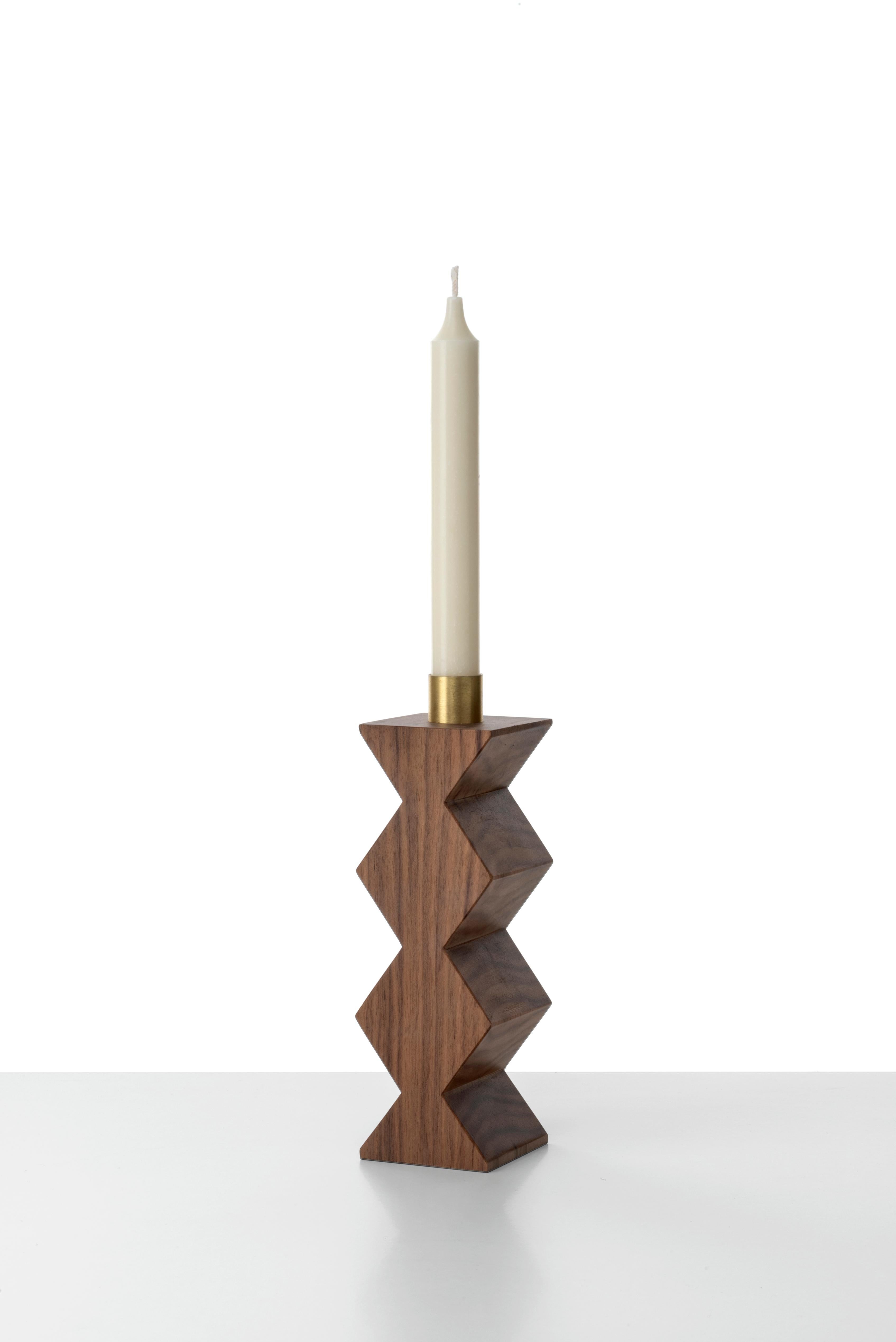 Constantin is a simple but charming candleholder with a geometric shape. The body of Constantin I is in solid oakwood shaped with circles; Constantin III in Canaletto walnut shaped with rhombus. The cylinder in natural brass on the top is the place