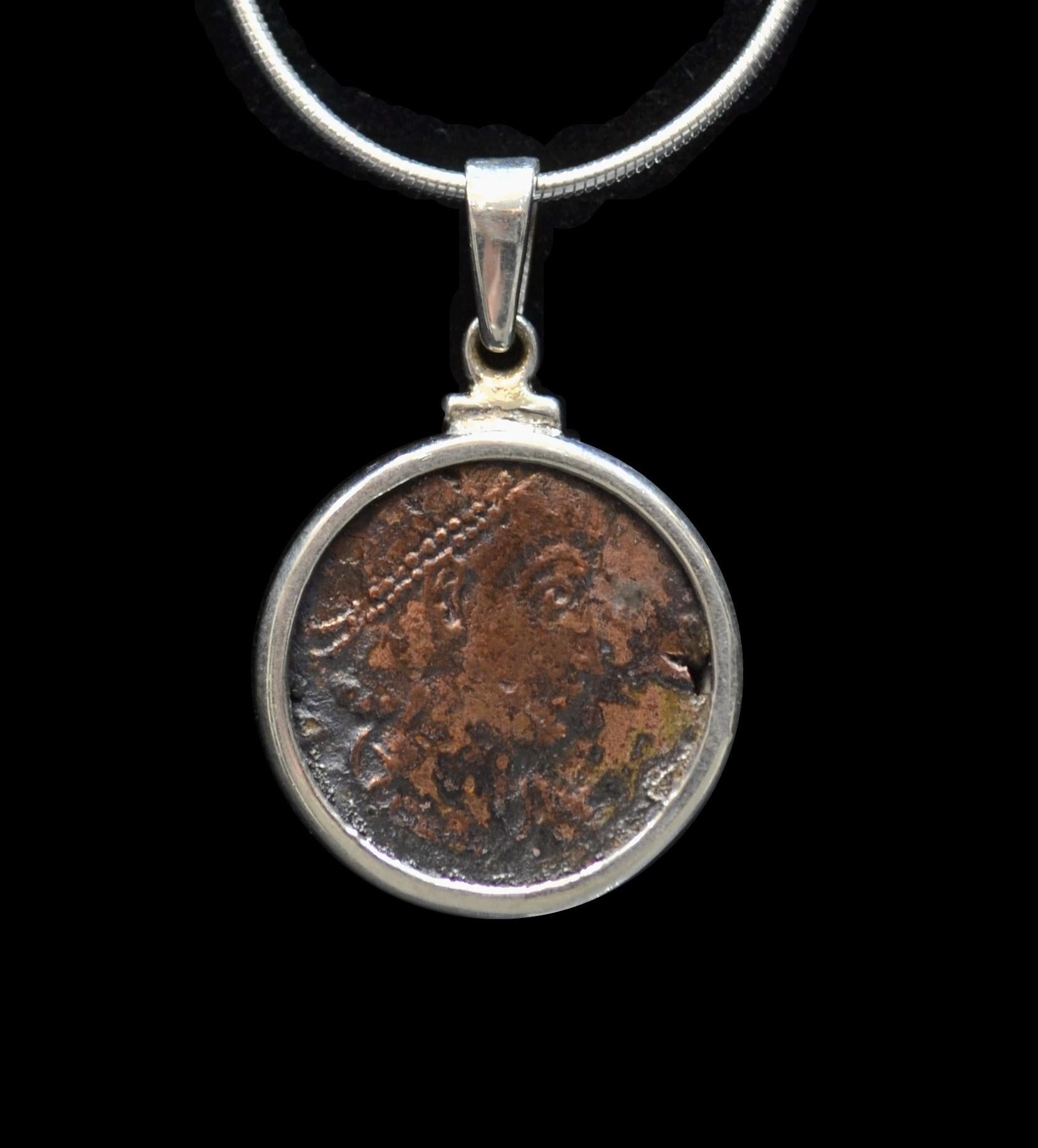 Antique Constantine The Great copper coin mounted on contemporary silver necklace. Ready to be worn!

Constantine was the son of Flavius Valerius Constantius, a Roman Army officer, and his consort Helena. He built Constantinople, created a new gold