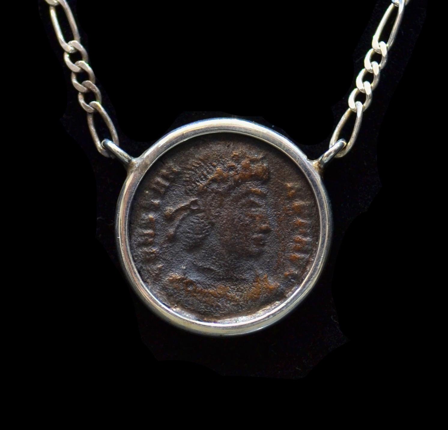 Antique Constantine The Great copper coin mounted on contemporary silver necklace. Ready to be worn!

Constantine was the son of Flavius Valerius Constantius, a Roman Army officer, and his consort Helena. He built Constantinople, created a new gold