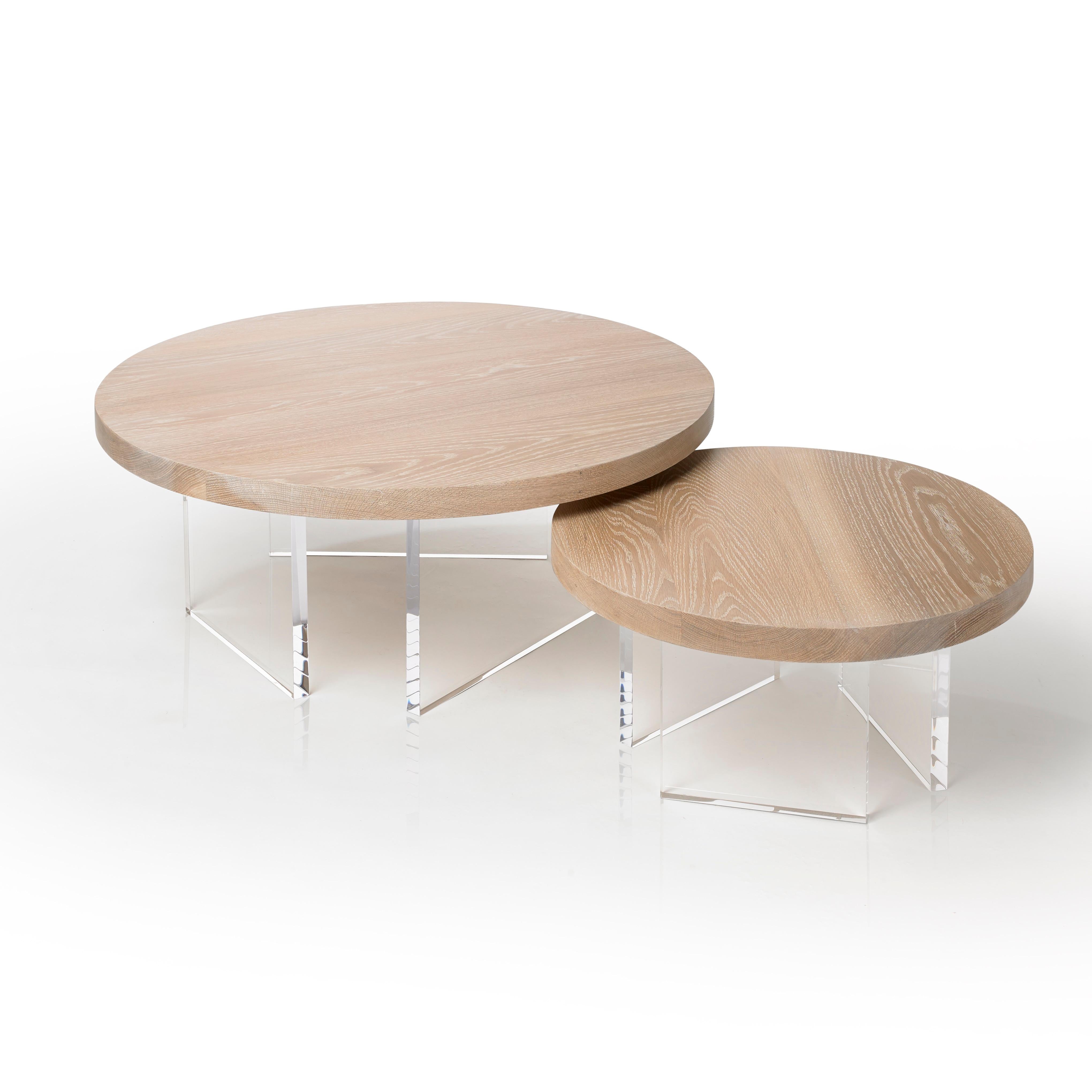 The Constantinople Round coffee table set is a modern wood and acrylic coffee table in White Oak that provides a warm feel with a touch of brilliance. The tabletop sits on three acrylic one-inch thick legs that allow light to pass through for an