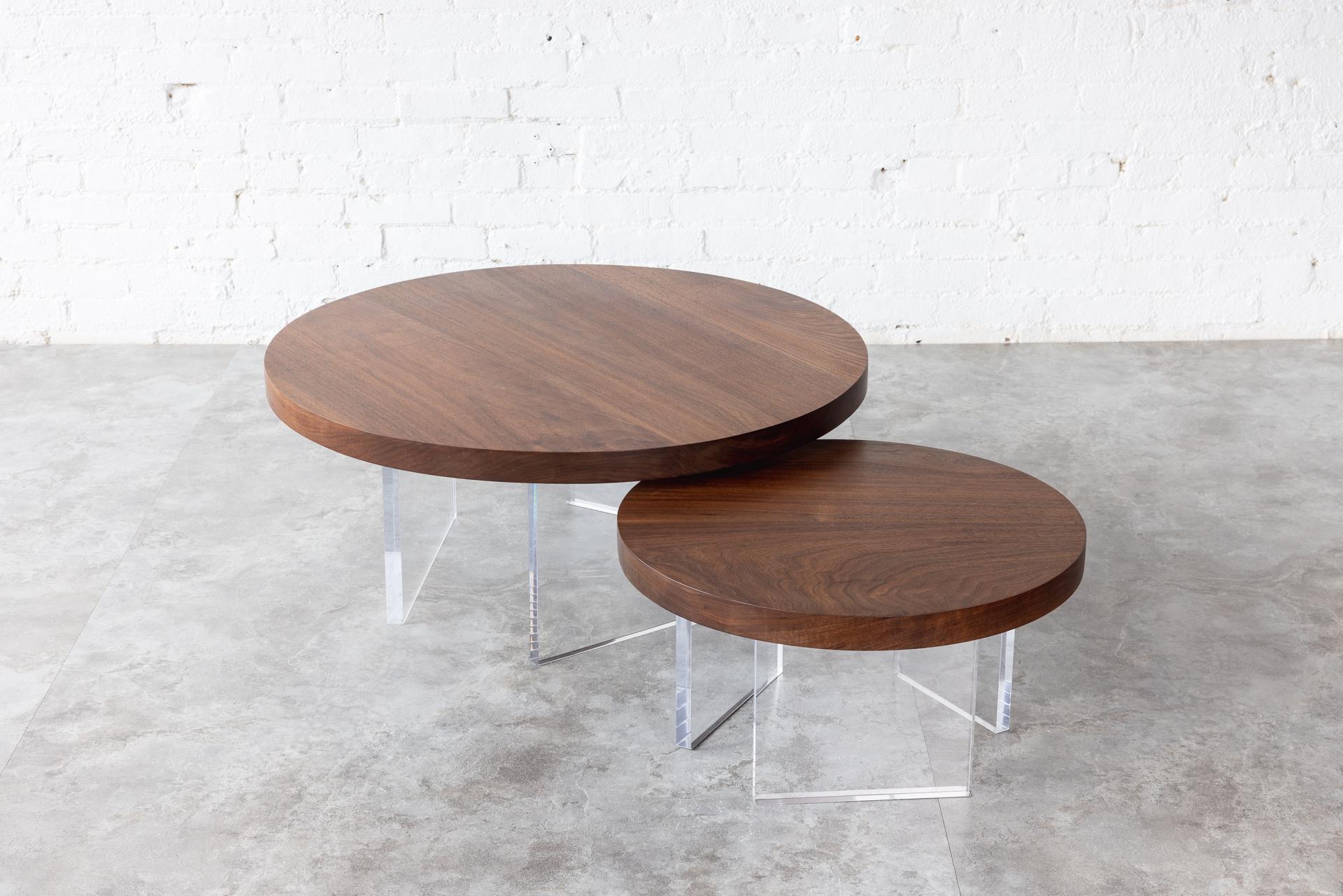 The Constantinople Round coffee table set is a modern wood and acrylic coffee table in Black Walnut that provides a warm feel with a touch of brilliance. The tabletop sits on three acrylic one-inch thick legs that allow light to pass through for an