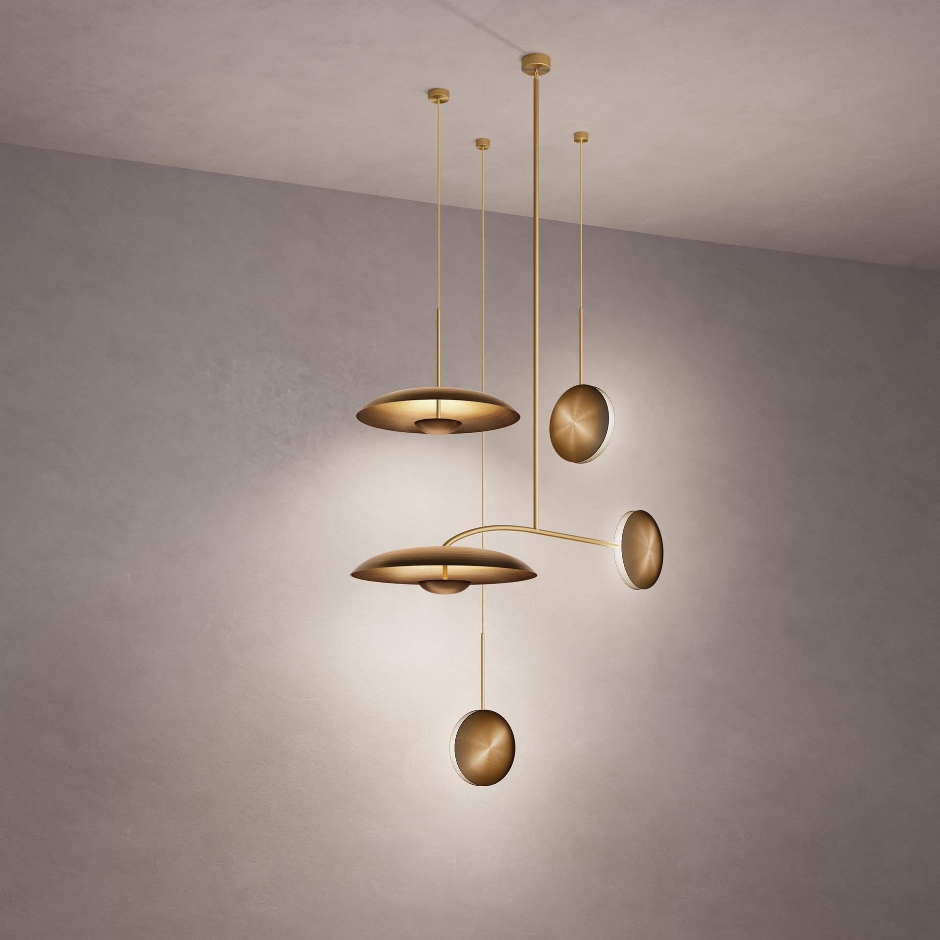Inspired by planet-like shapes and textures, the Cosmic collection plays with both metal properties and a selection of patina finishes.
 
Finished in Atelier001’s signature bronze gradient patina Ore, the four lighting components are harmoniously
