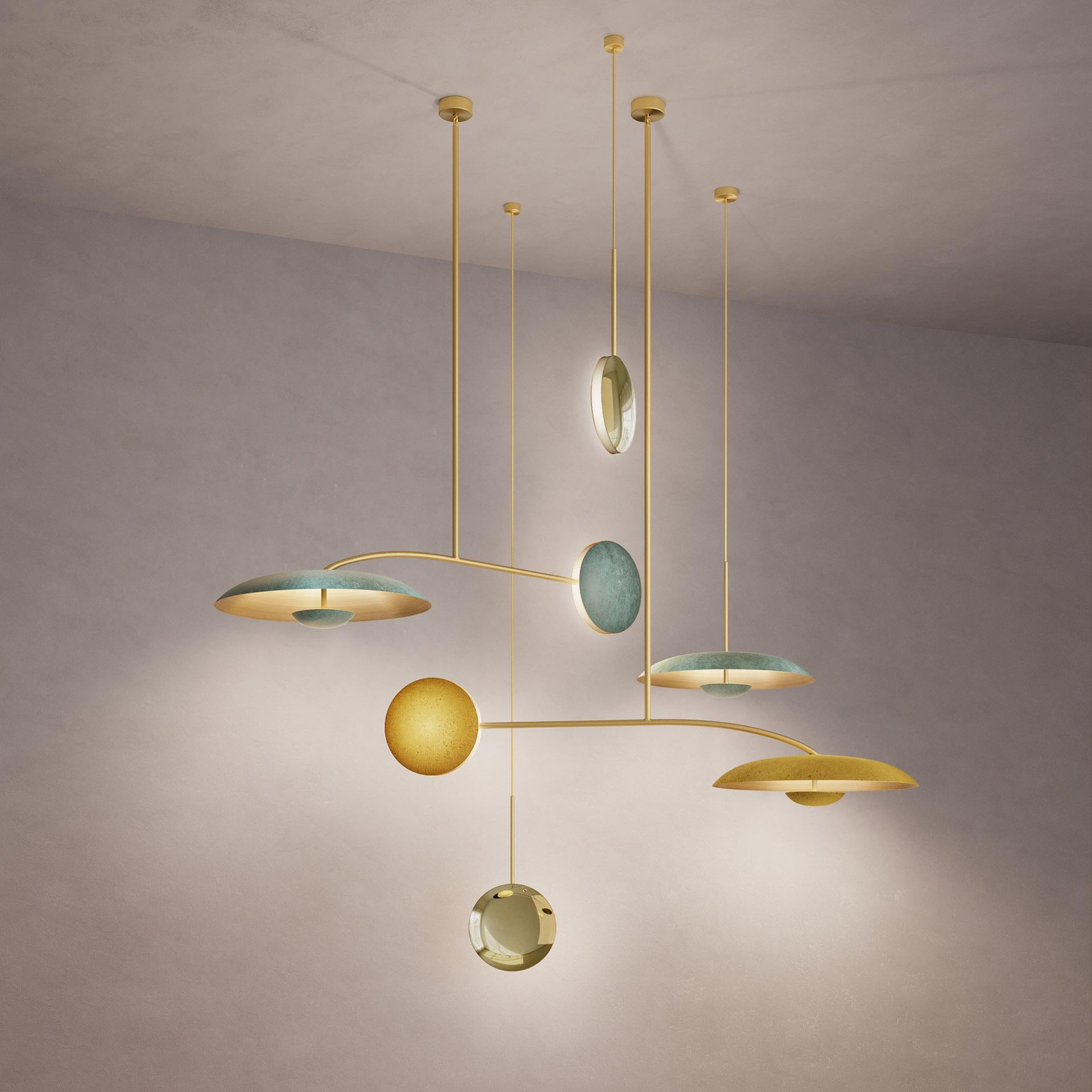 Inspired by planet-like shapes and textures, the Cosmic collection plays with both metal properties and a selection of patina finishes.
 
Finished in Atelier001’s signature bronze gradient patina Ore, the five lighting components are harmoniously