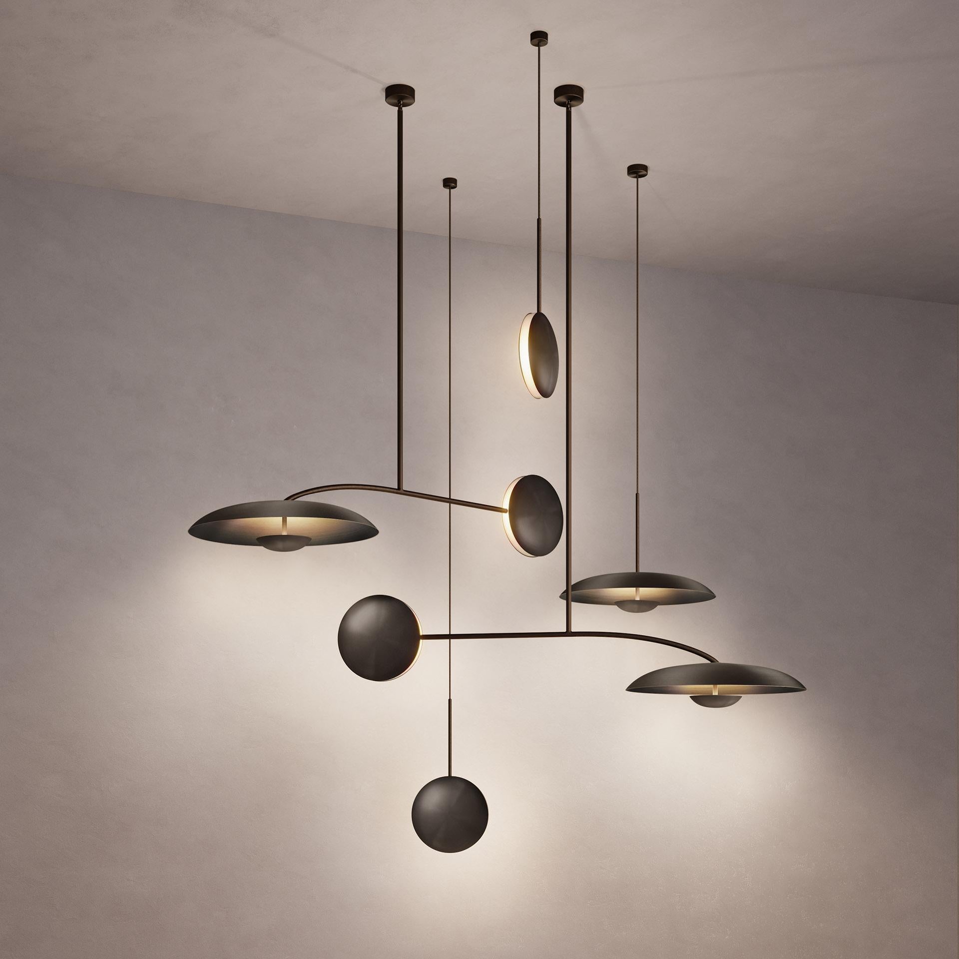 Inspired by planet-like shapes and textures, the Cosmic collection plays with both metal properties and a selection of patina finishes.
 
Named after the natural dark rock material Regolith, the five lighting components are harmoniously balanced