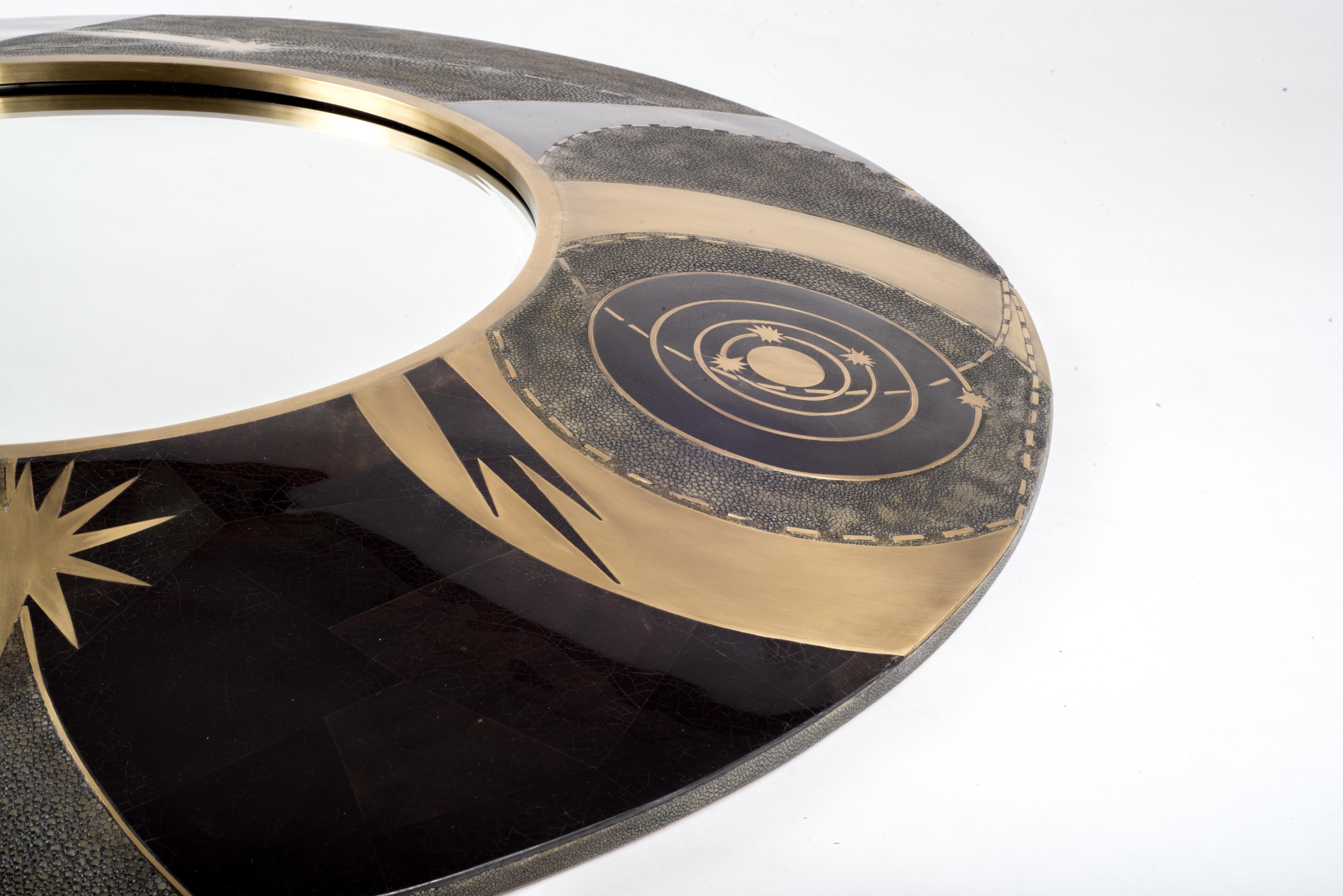 The constellation dark mirror is a statement piece with it’s celestial inspired roots. The mirror can be hung in 3 different ways. Available in a smaller size and cream finish (image at end of the slide). The shagreen is hand-dyed by artisans and