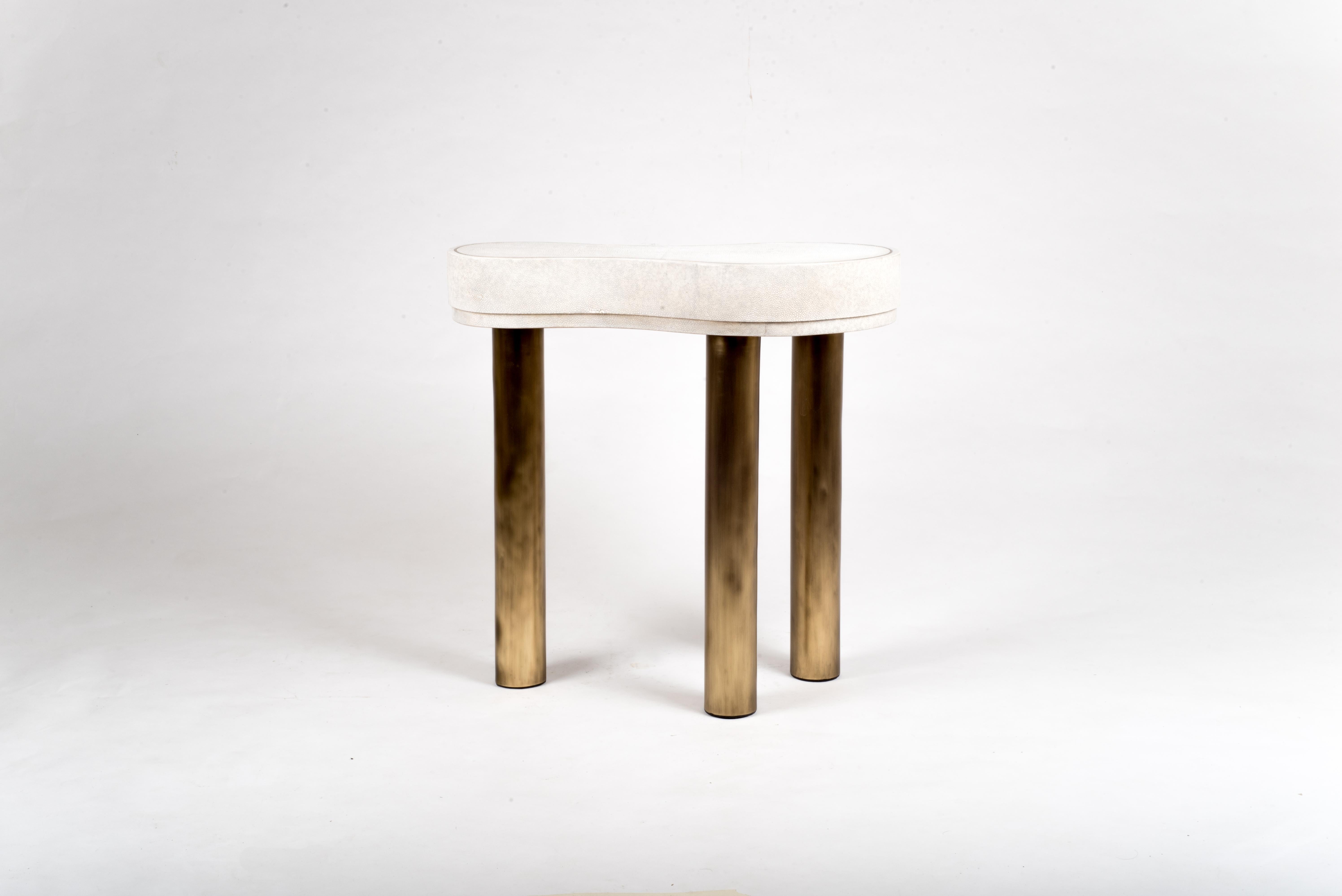 The constellation side table is whimsical and elegant with its amorphous shape. The shagreen is hand-dyed by artisans and the designer calls the final finish “Antique Natural” shagreen. The piece has beautiful discreet details of a metal indentation