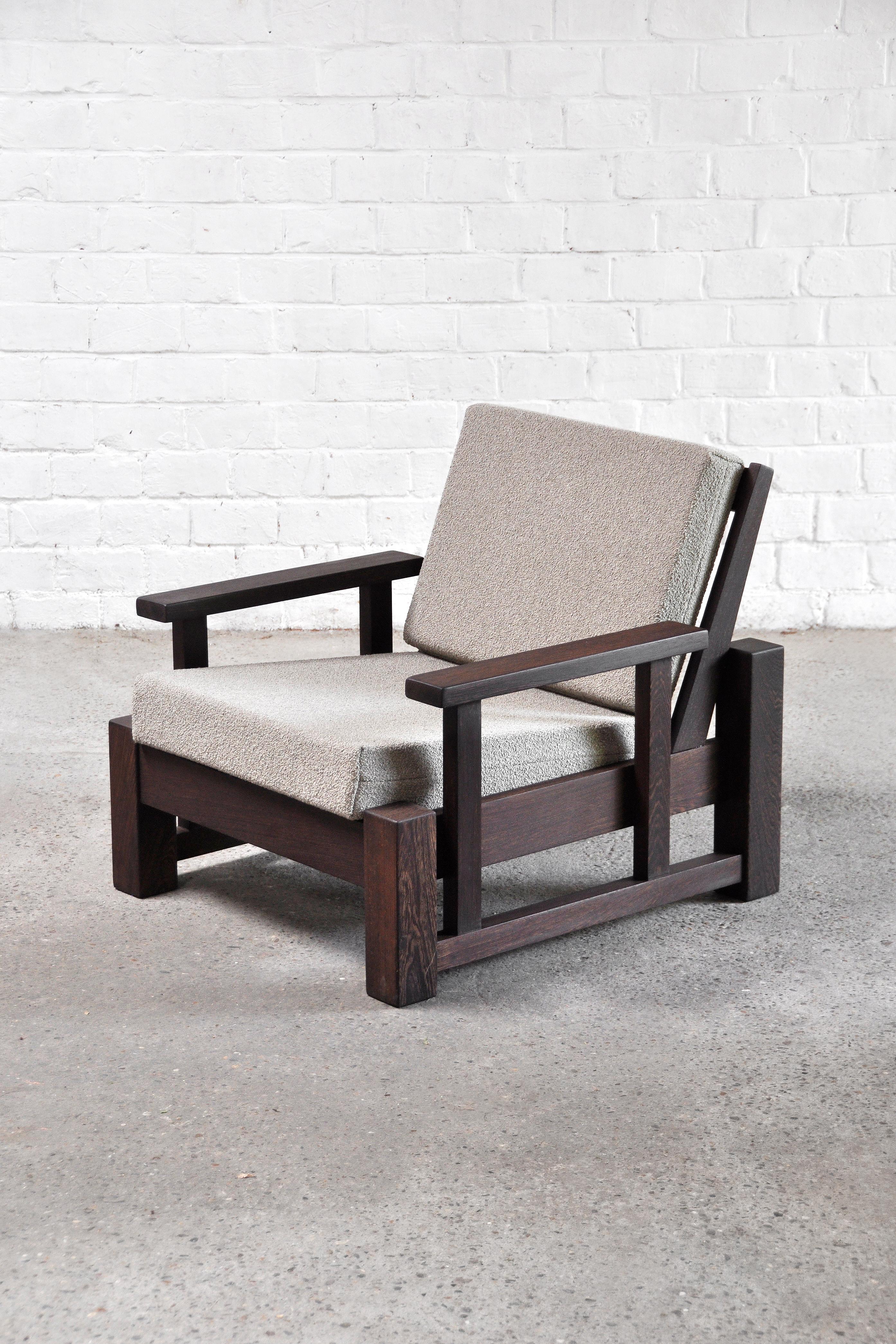 A constructivist/modernist armchair made of a solid wengé wooden frame, Netherlands 1960’s. The chair is finished with a re-upholstered taupe bouclé fabric. Thanks to the use of geometrical design elements, a boxy and strong look is created while