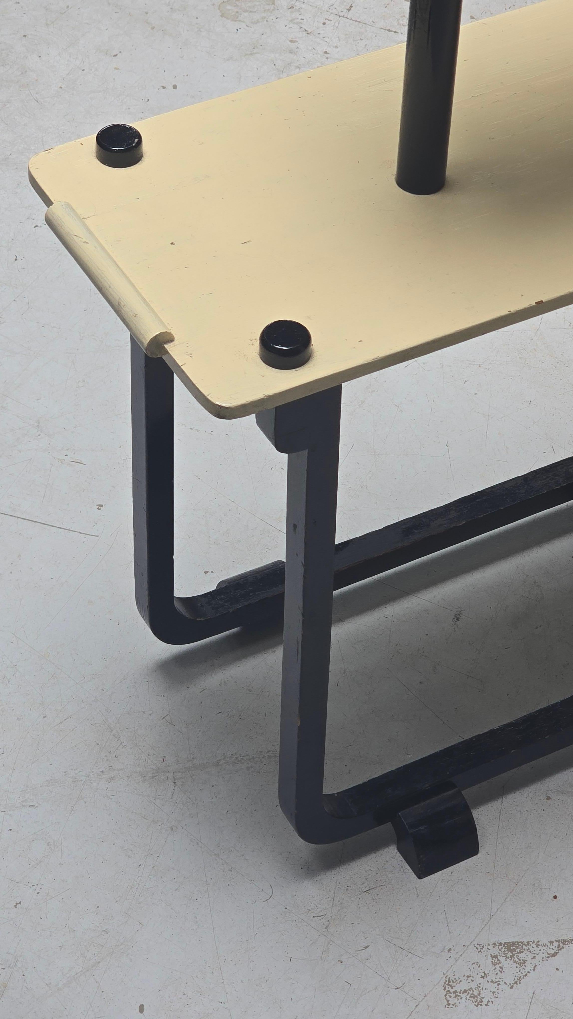 Crafted in France c. 1925 and attributed to André Groult, this constructivist plant stand presents a striking interplay of sculptural form and functional design. Fashioned in solid wood with a bold black-lacquered frame and four asymmetrically
