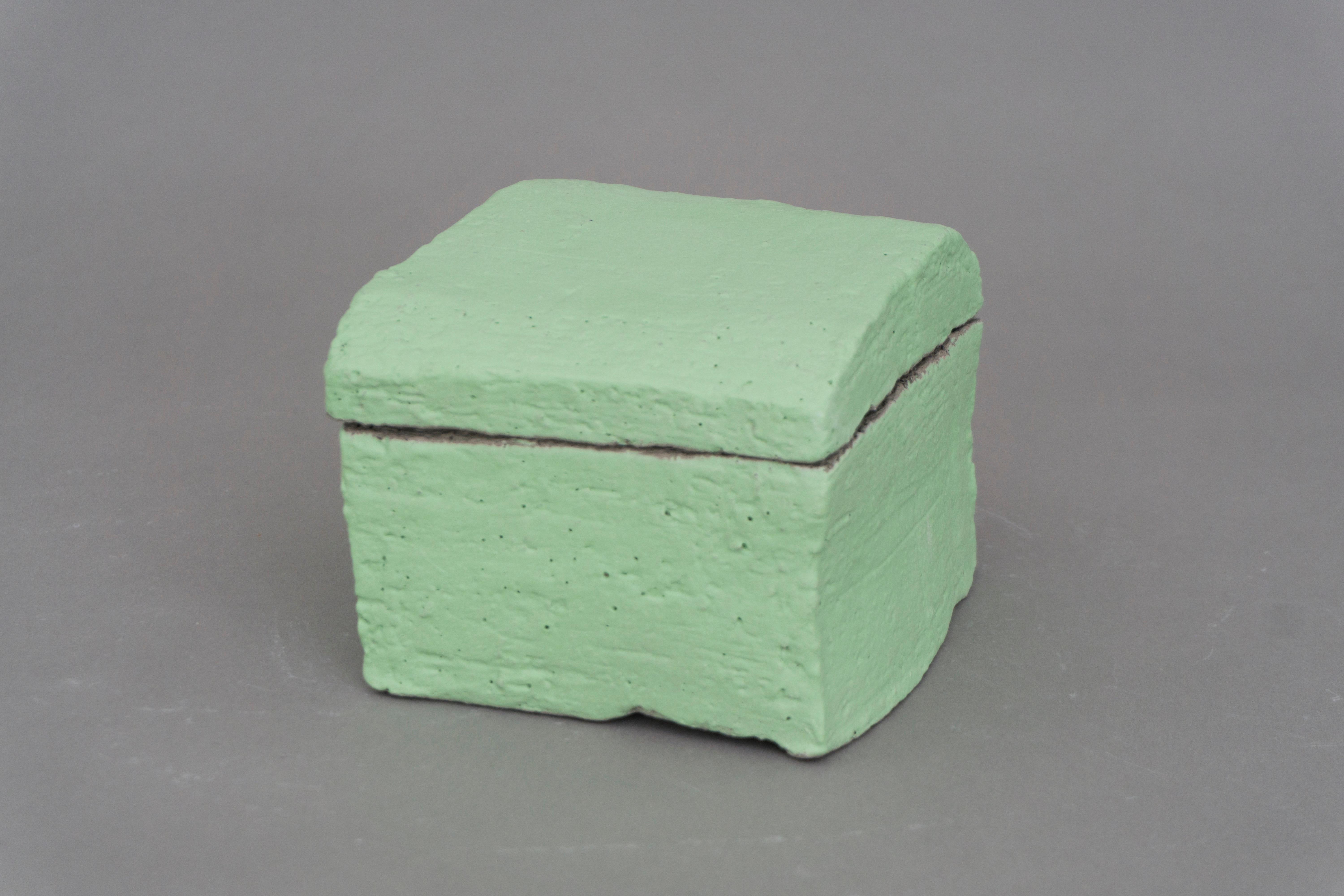 Unique square container by Christine Roland with a lid. Made of grey stoneware with a fresh pale green engobe by designer Christine Roland. Matt finish and a heavy feel. Store your precious items!

'Christine Roland is a Berlin-based, Danish