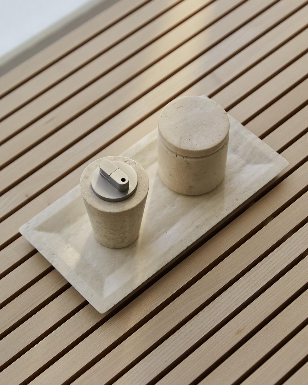 A small container made from a solid block of Italian travertine stone. Features a beveled base with a silicone sealed lid. Honed smooth finish inside and out with an engraved logo on the bottom. Comes packaged in a custom gift box.

Founded in 2023