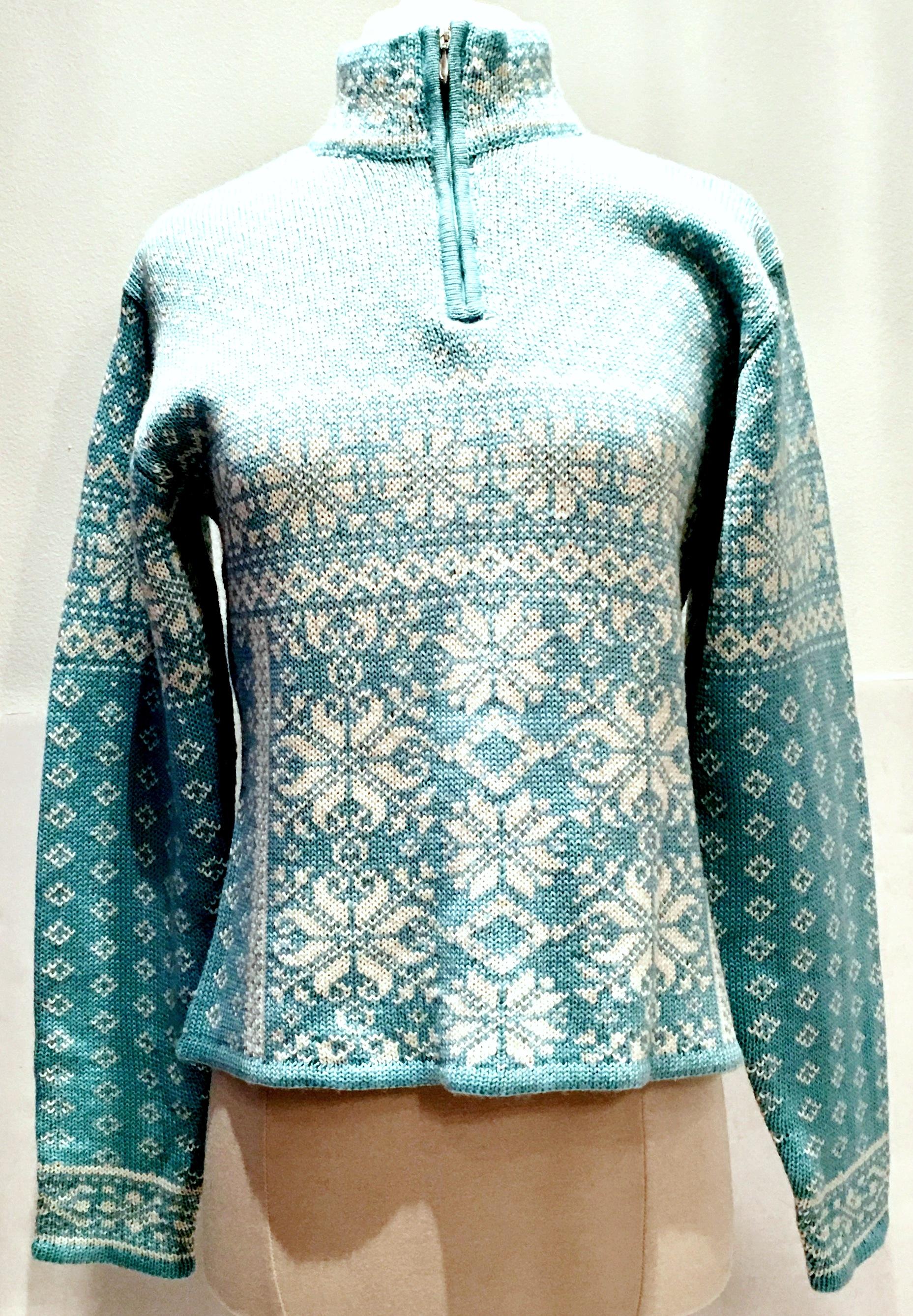 Contemporary & New Vibrant Baby Blue & White Snowflake ski sweater by Obermeyer for Gorsuch. Made of soft wool and acrylic blend with a silver chrome front neck zipper. Marked a Ladies Medium. 
New, without tags, never worn