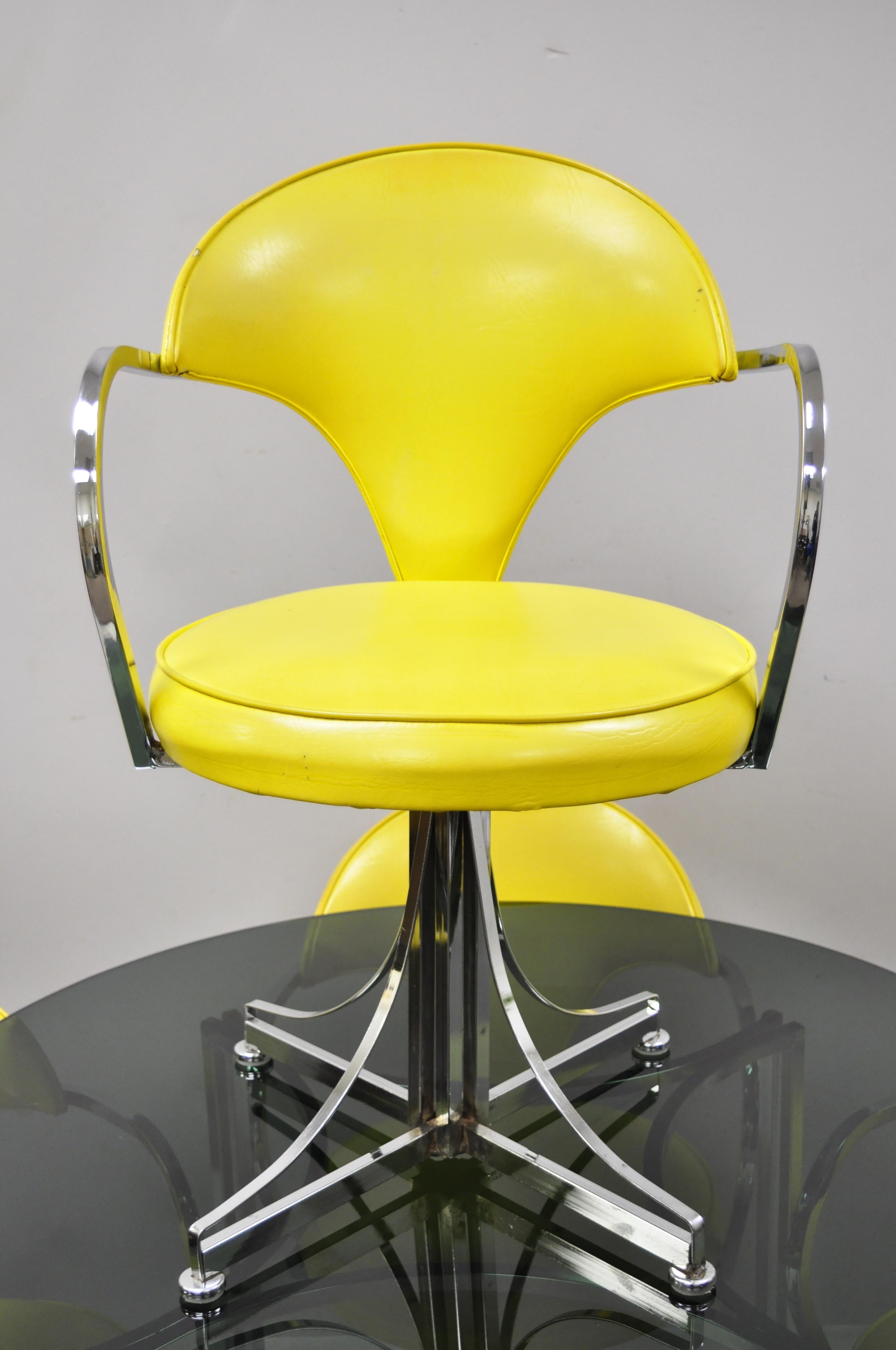 Contempo Frames Inc. Mid-Century Modern yellow vinyl chrome frame dining set, 5 pieces. Set includes (4) chairs, (1) smoked glass top table, chrome base, yellow vinyl upholstery, swivel seats, very nice vintage set, circa mid-20th century.