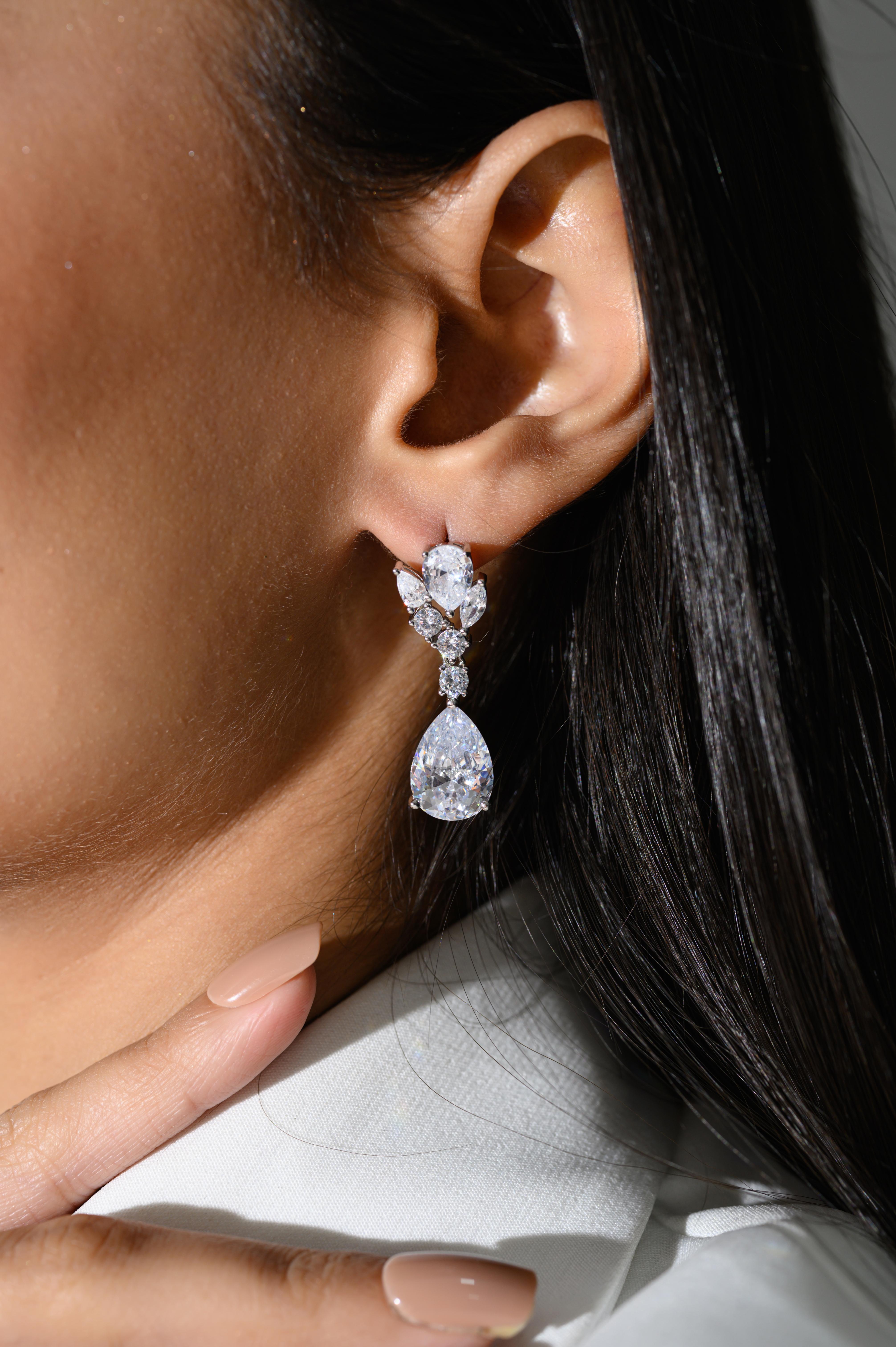 Contemporar Teardrop Leaf Cubic Zirconia Wedding Earrings in sterling silver. You shall need these statement drop earrings to make a statement with your look. Each piece features dazzling cubic zirconia stones, renowned for their brilliance and