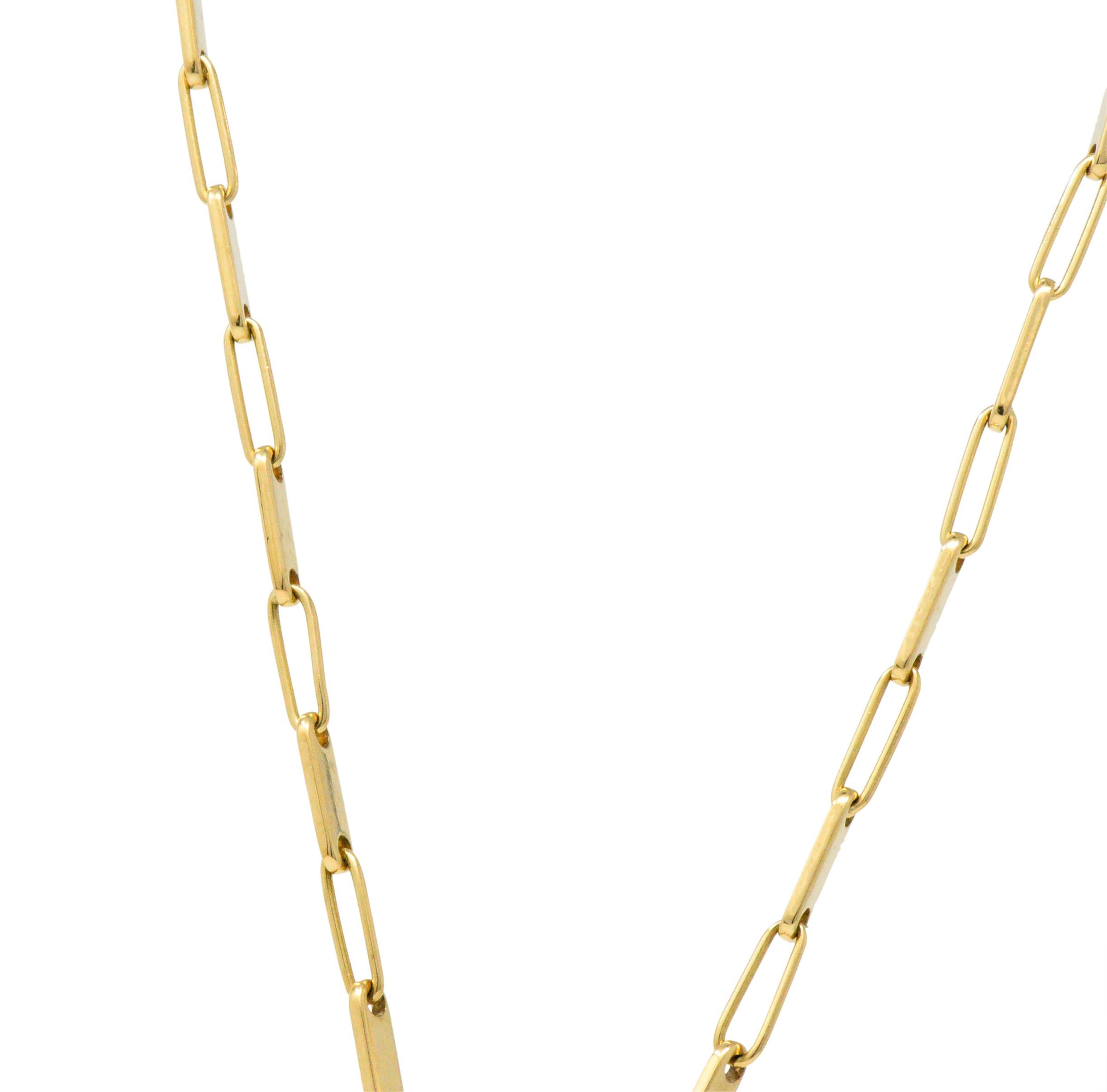 Designed as an articulated abstract fish, with round brilliant cut diamond eyes and accents, approximately 0.10 carats total, white and eye-clean

Bright polished gold sections of the fish move well and give the necklace whimsy

On a bar and link