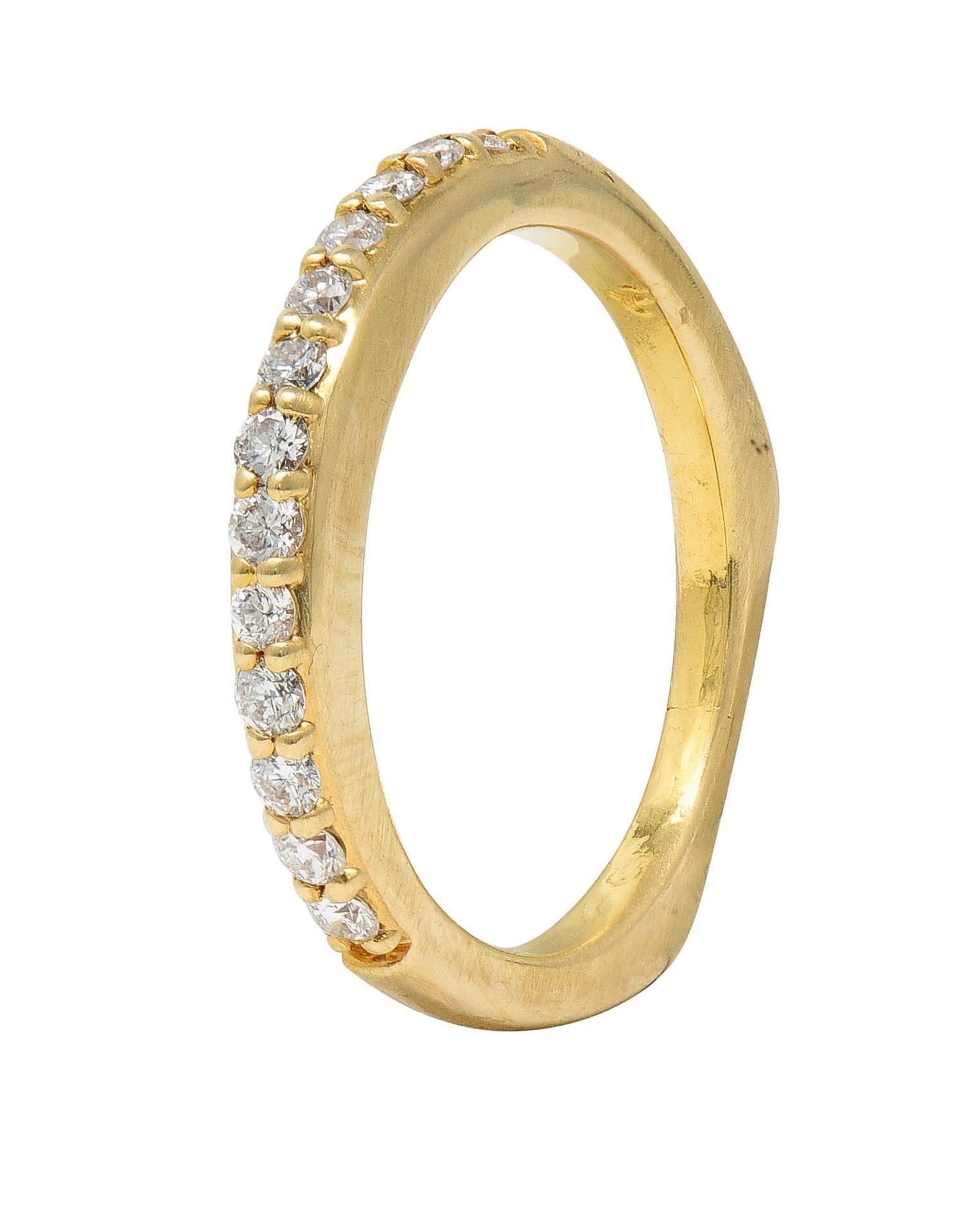 Featuring a row of round brilliant cut diamonds prong set to front
Weighing approximately 0.26 carat total 
G color with VS2 clarity
Completed by squared off shank
Stamped for 14 karat gold
With partial maker's mark
Circa: 2000s
Ring size: 5 1/4 and
