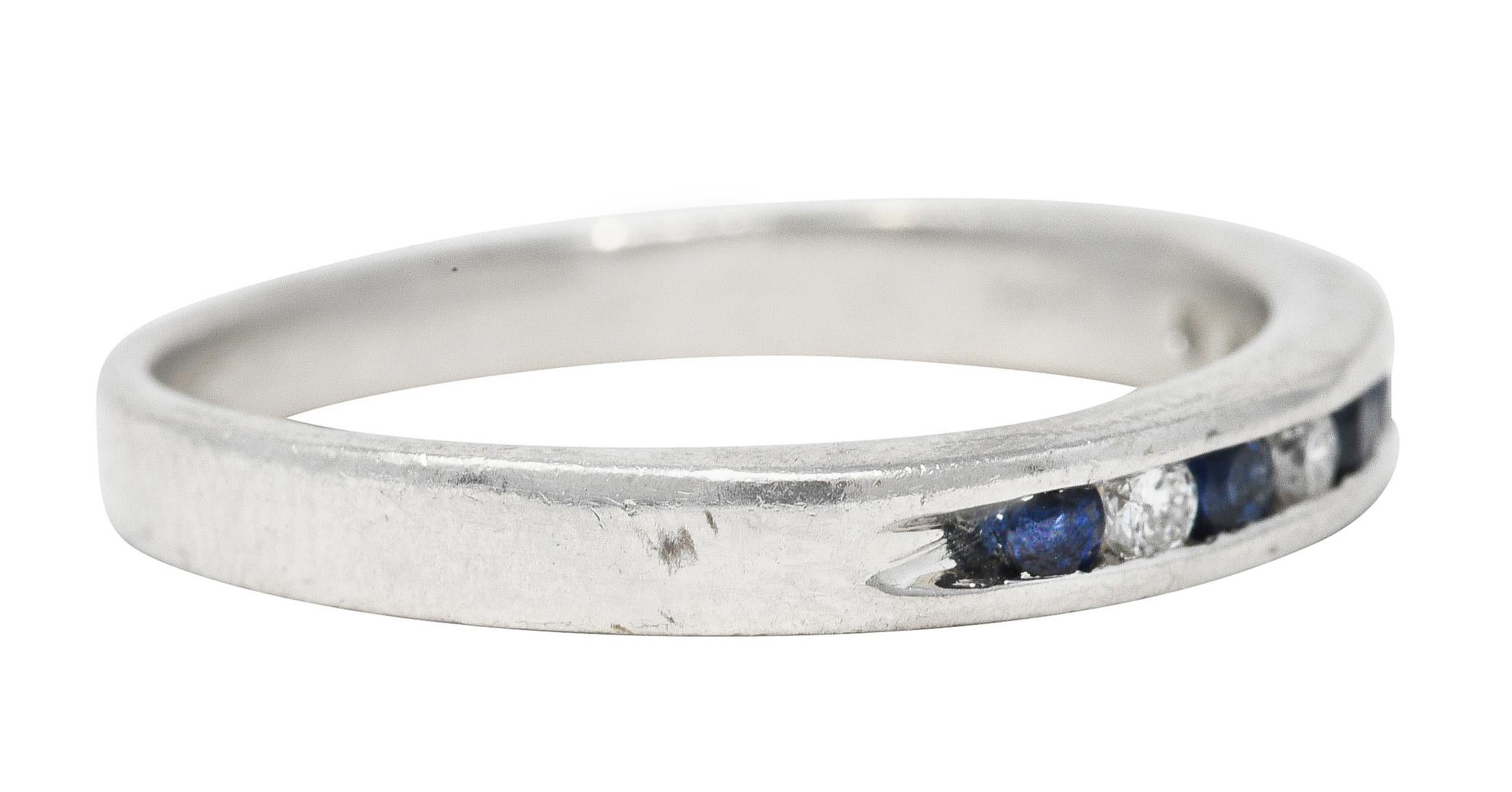 Band ring features four round brilliant cut diamonds channel set to front

Weighing approximately 0.12 carat total - eye clean and bright

Alternating with five round cut sapphires weighing approximately 0.21 carat total

Semi-transparent blue with