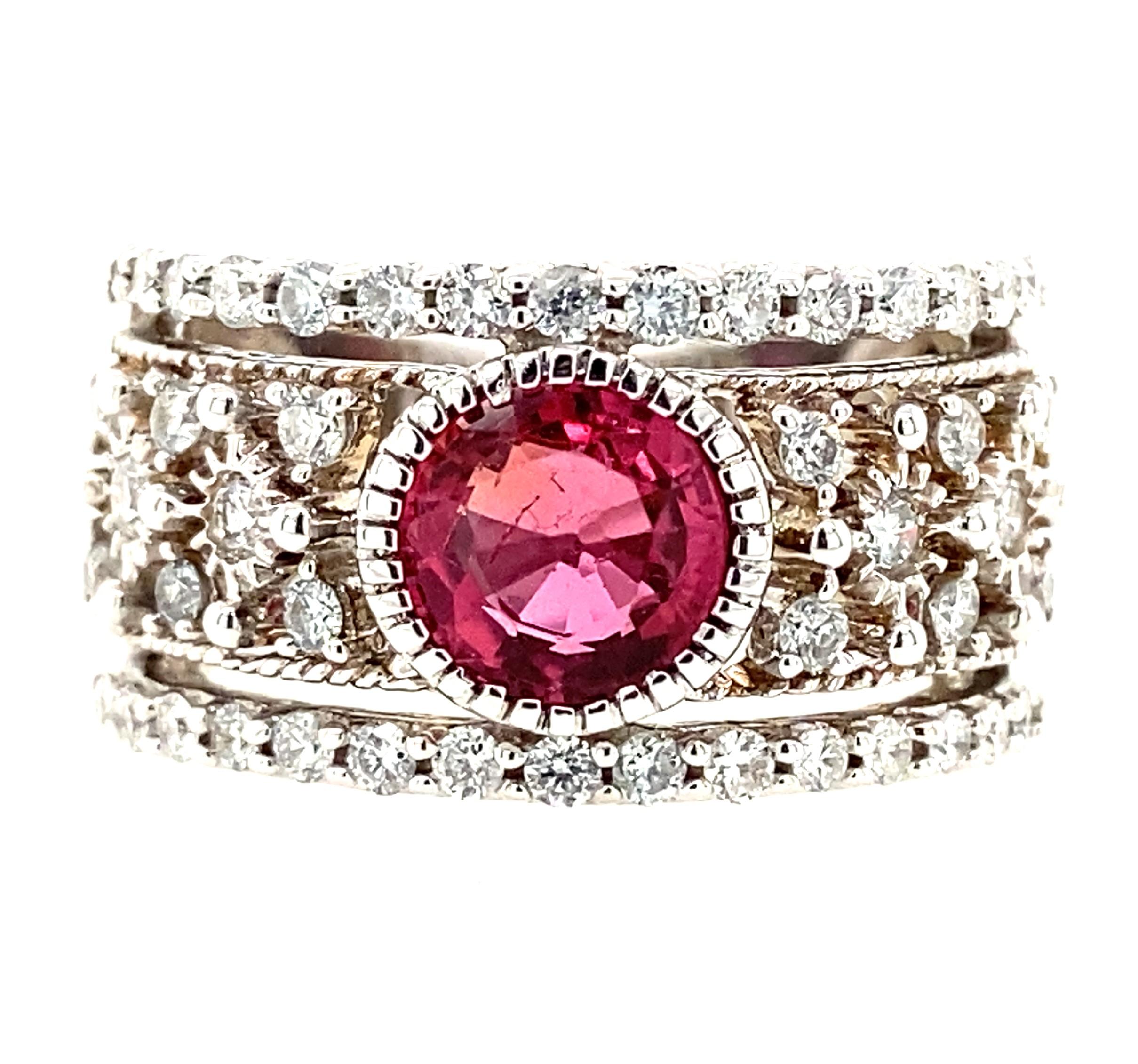 This contemporary 14 karat white gold pink tourmaline and diamond ring makes a statement with its luscious pink color and wonderful presence on the finger!  The ring is bold in effect but has the sweetness of the alluring pink gem weighing 0.49