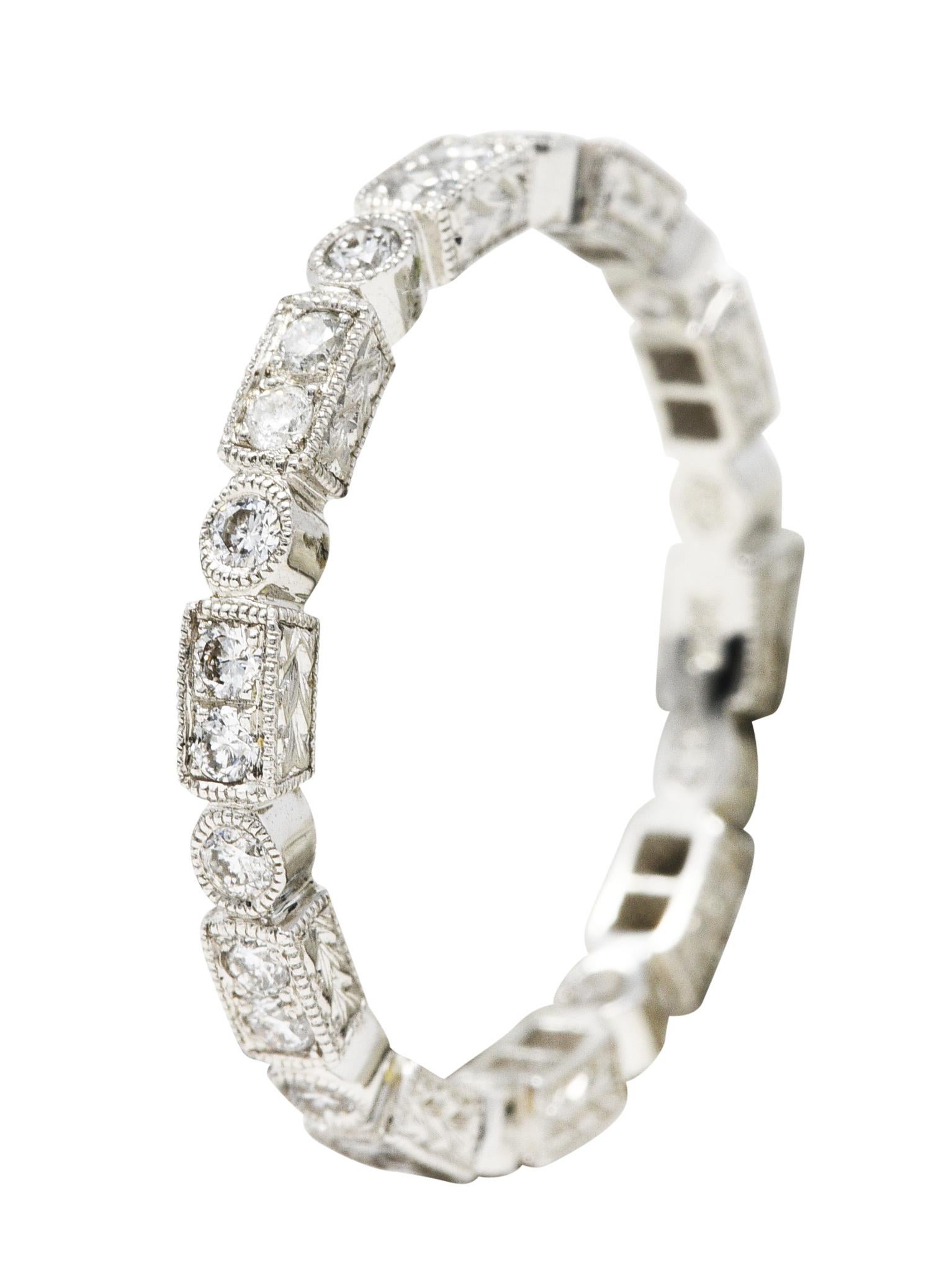 Eternity band ring is designed as a geometric pattern with milgrain

Rectangular forms alternate with circular forms while accented by round brilliant cut diamonds

Weighing in total approximately 0.50 carat with G/H color and VS clarity

Completed