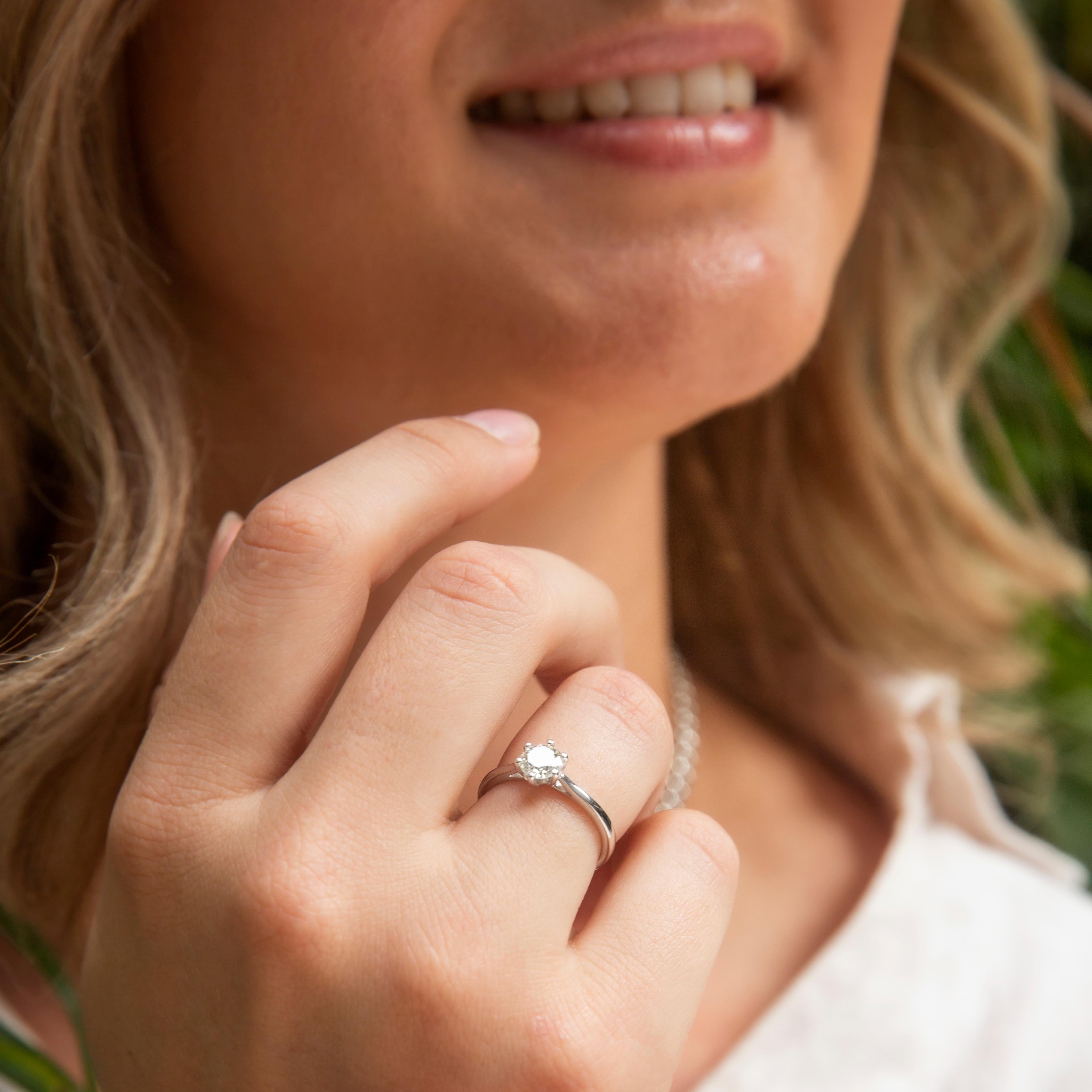 Forged in 18 carat white gold, this fabulous contemporary solitaire ring features a gorgeous 0.66 carat round brilliant cut diamond perched atop a gleaming band. This delightful ring is named The Orla Ring. With a centrepiece diamond perched just