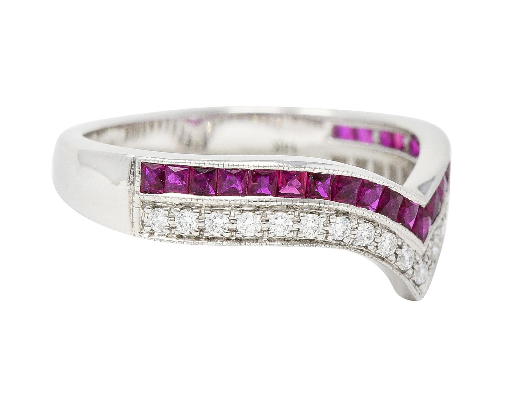Designed as a pointed chevron motif contour style band featuring one row each of rubies and diamonds. Rubies are French cut and weigh approximately 0.54 carats total. Transparent purplish red in color and channel set to front. Diamonds are round