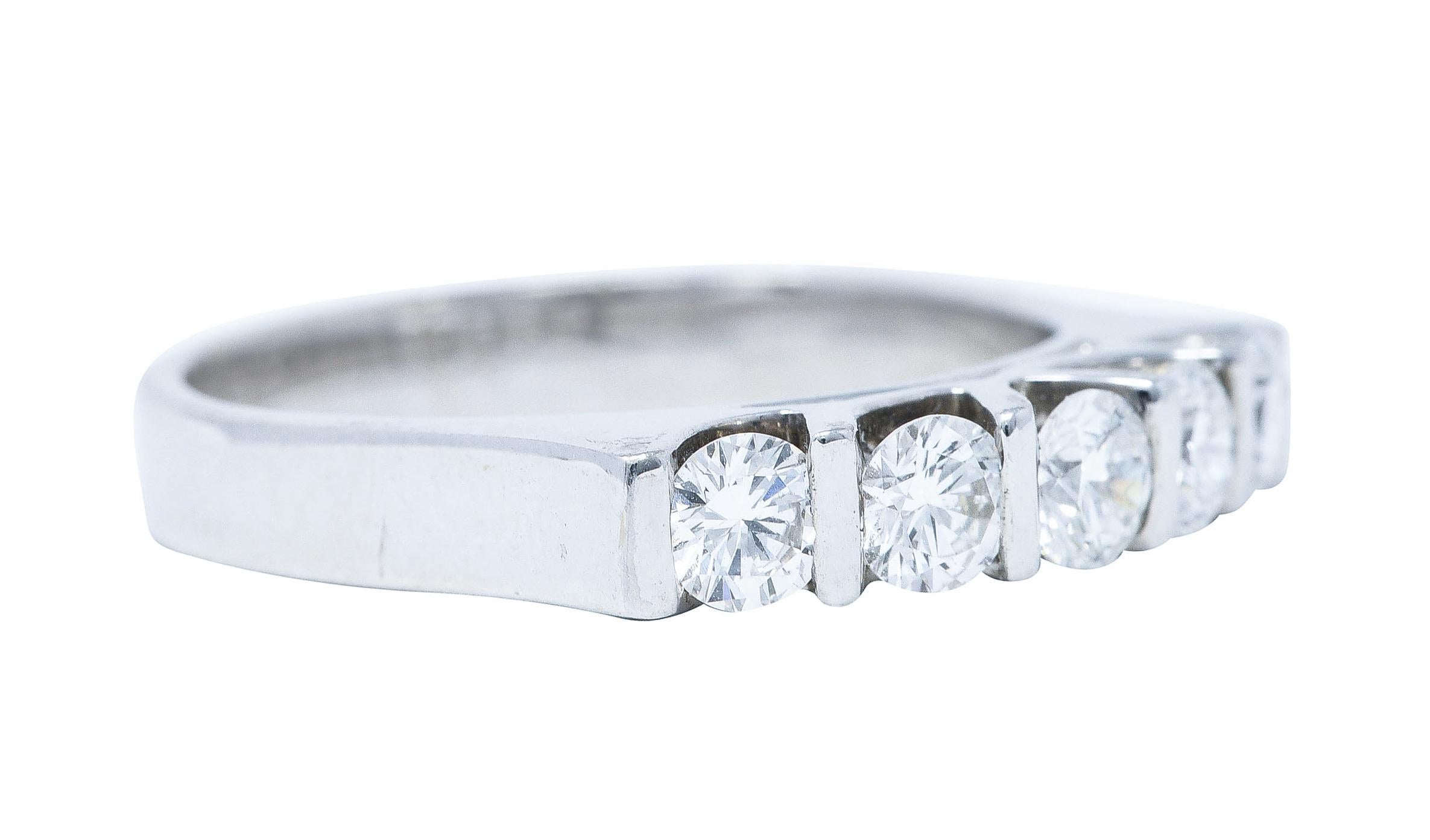 Band ring features five round brilliant cut diamonds bar set to front

Weighing approximately 0.75 carat total - G/H in color with VS clarity

With a stylized profile and high polished finish

Stamped 18K for 18 karat white gold

With maker's