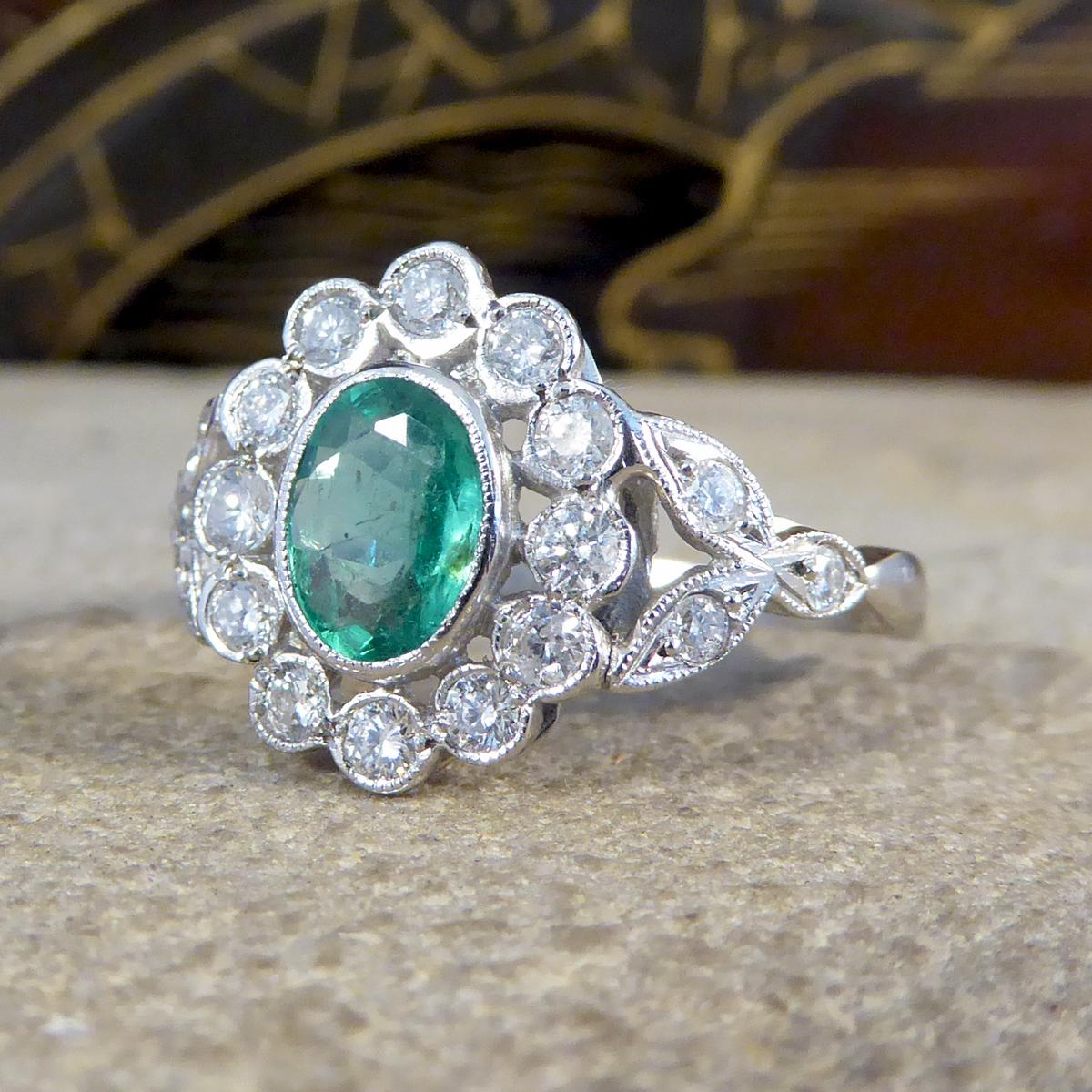 Contemporary 0.75ct Emerald and Diamond Cluster Ring with Shoulders in Platinum In Good Condition In Yorkshire, West Yorkshire