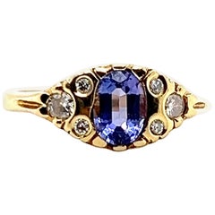 Anillo contemporáneo de oro amarillo de 18 quilates con tanzanita de 0,78 quilates y diamantes