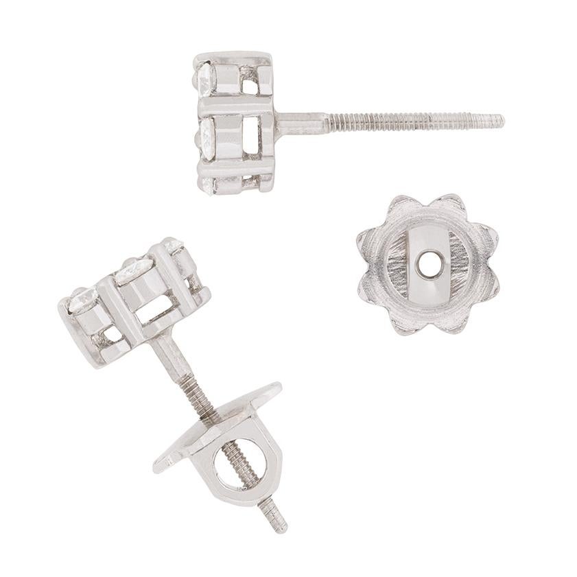 The centre diamond of each earring weighs 0.10 carat, and is surrounded by further round brilliants each weighing 0.05 carat, bringing the total to 0.40 carat on each earring. The sparkling diamonds shine in their claw setting and have been
