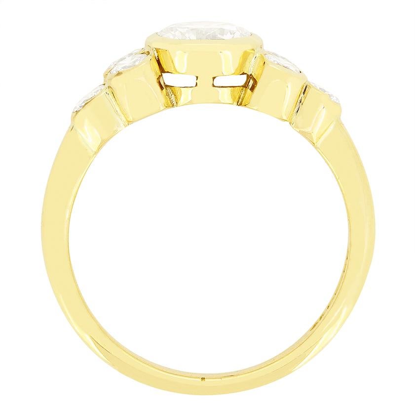 Dieser wunderschöne Solitärring wurde in den 1990er Jahren hergestellt. In seiner Mitte funkelt ein runder Brillant in Reibung. Der Diamant hat ein Gewicht von 0,80 Karat, eine Farbe von G und eine Reinheit von VS1. Der zentrale Stein wird von einem