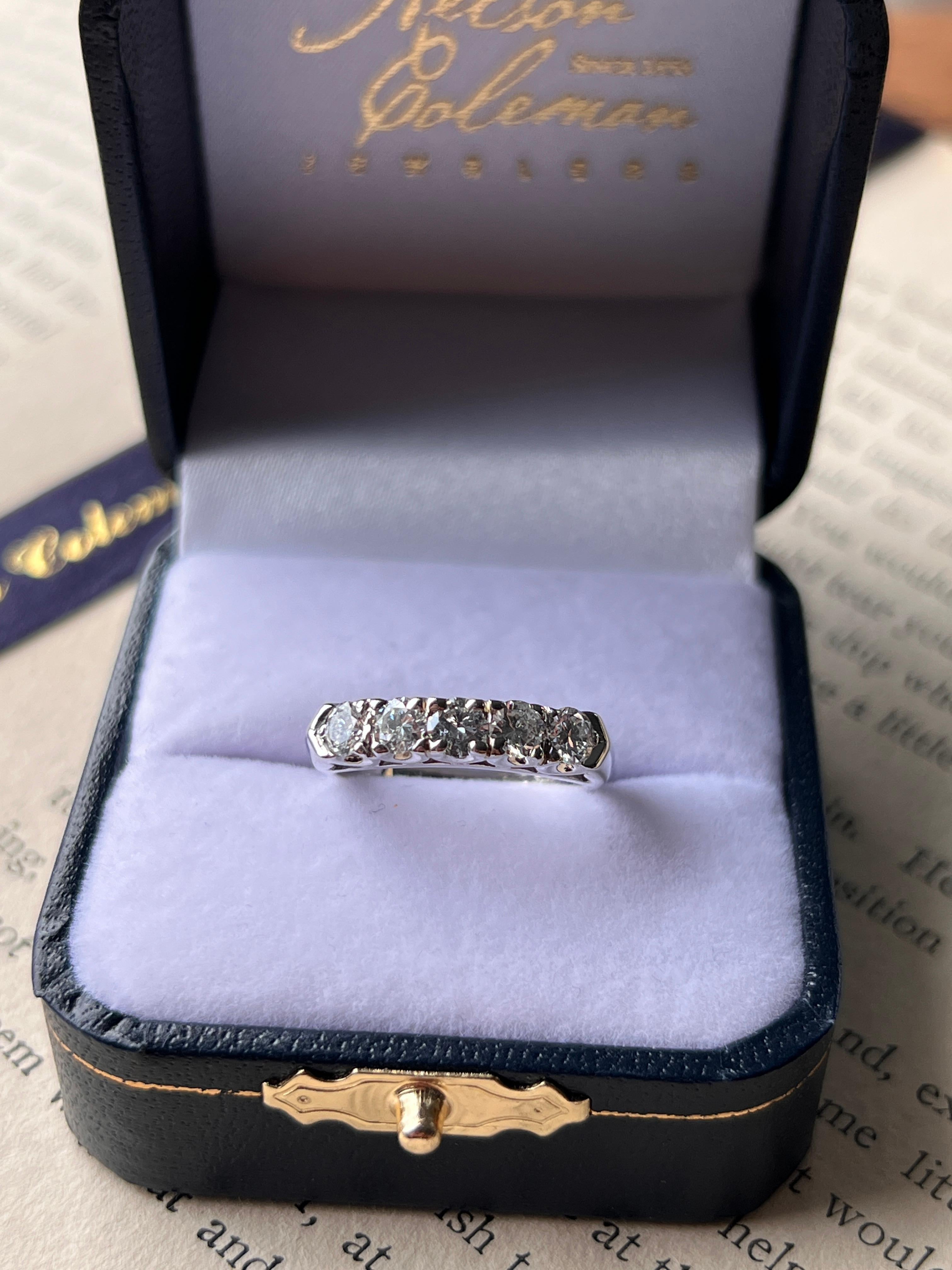 One contemporary 14 karat white gold five-stone diamond band set with five round brilliant diamonds weighing approximately 0.85 carats in total, with G–H color and I1 clarity. The classic five-stone design offers a timeless look, perfect worn alone,