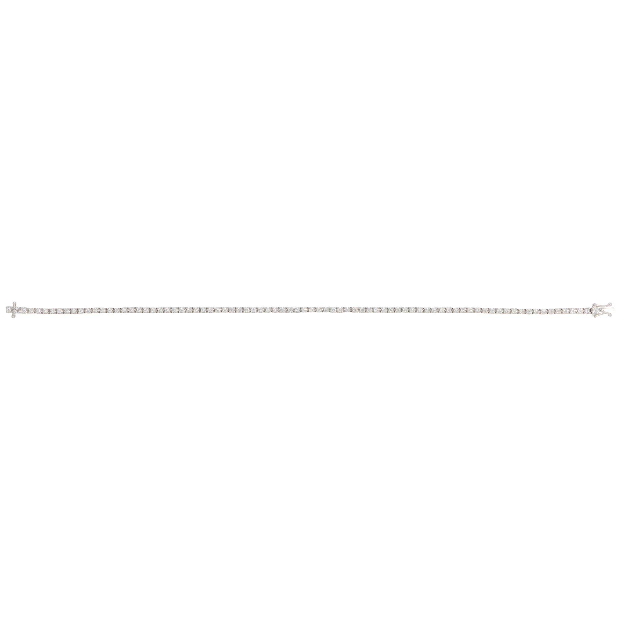A beautiful contemporary diamond line tennis bracelet set in 18k white gold.

The bracelet is composed of a grand total of 82 round brilliant-cut diamonds. All stones are securely four-prong set and perfectly matched in size.

The articulated links