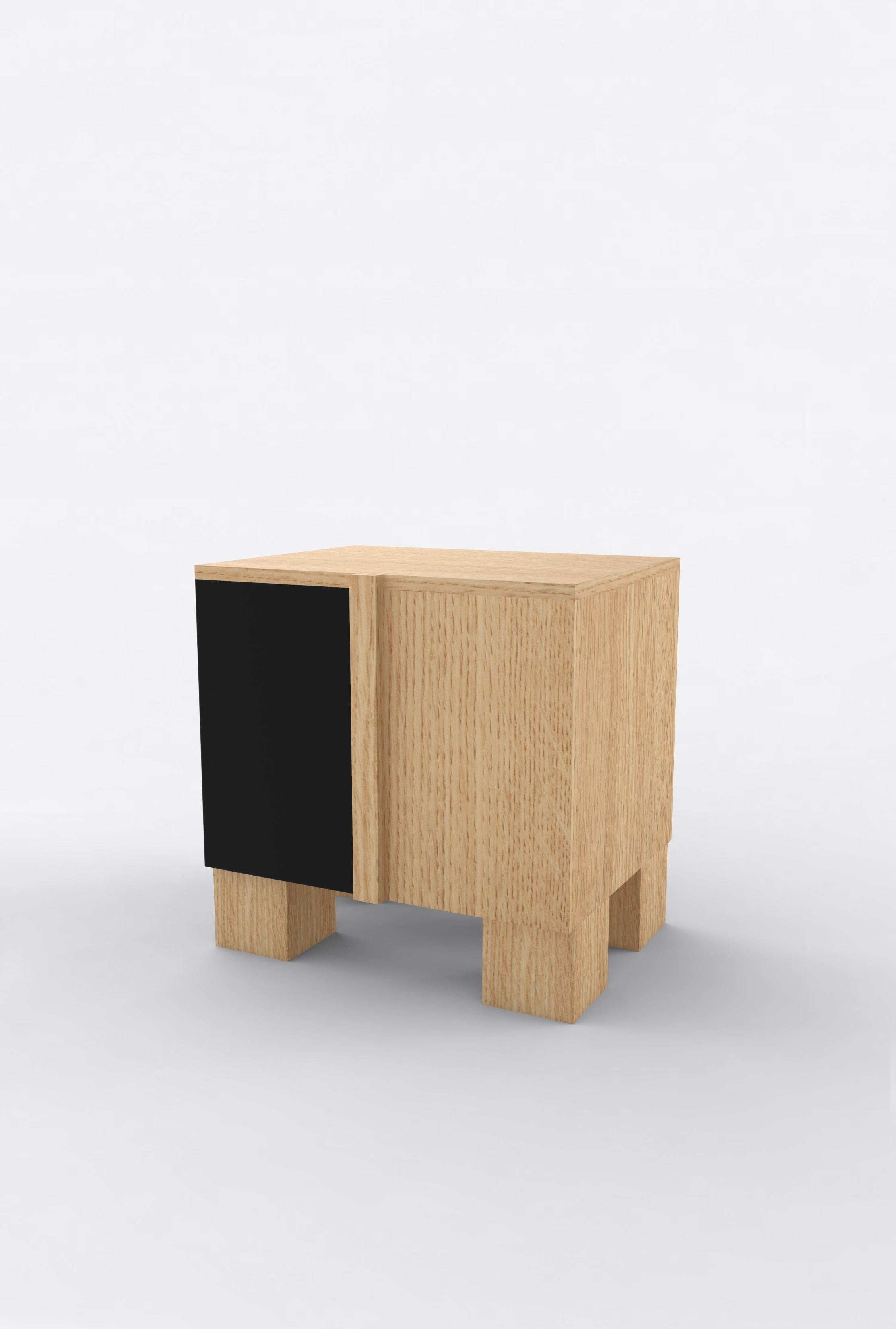 Orphan Work 100 Bedside
Shown in oak and black.
Available in natural oak with painted door. 
Measures: 24” W x 15” D x 22” H
2 doors with adjustable shelves. 

Orphan work is designed to complement in the heart of Soho, New York City. Each piece is
